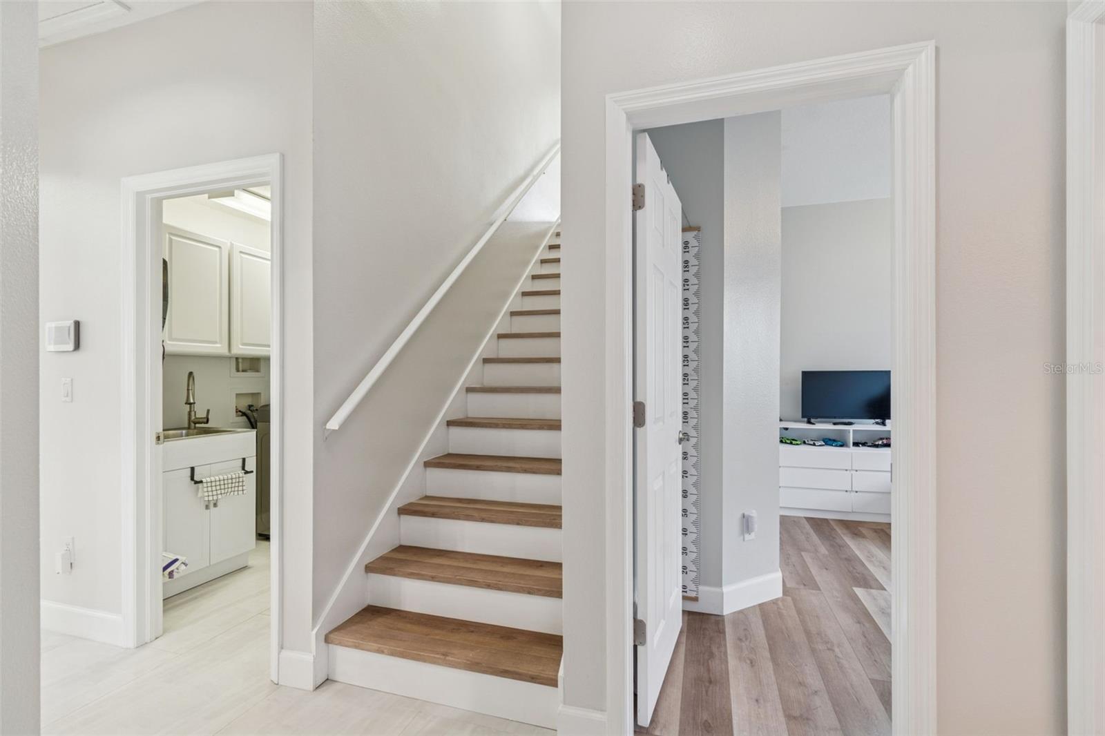 Laundry room is off the garage and has a washer/dryer as well as new sink. Lots of storage here.