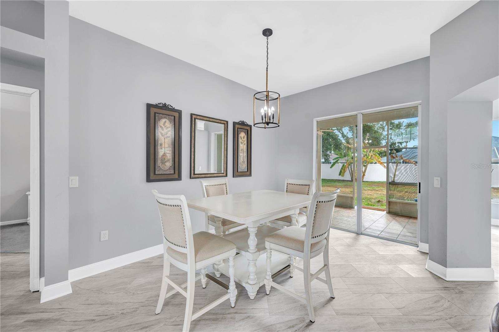 The dining room offers direct access to the screened lanai through expandable pocket sliding doors.
