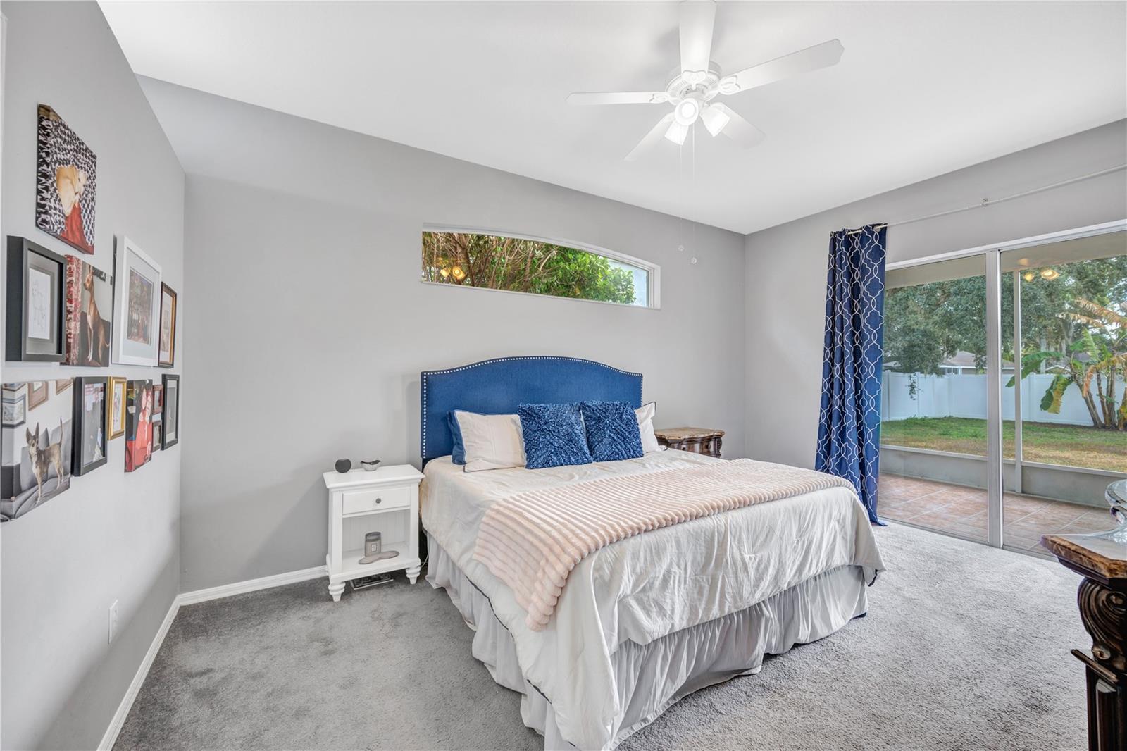 The spacious primary suite is a true retreat, offering sliding doors to a large tiled and screened lanai.