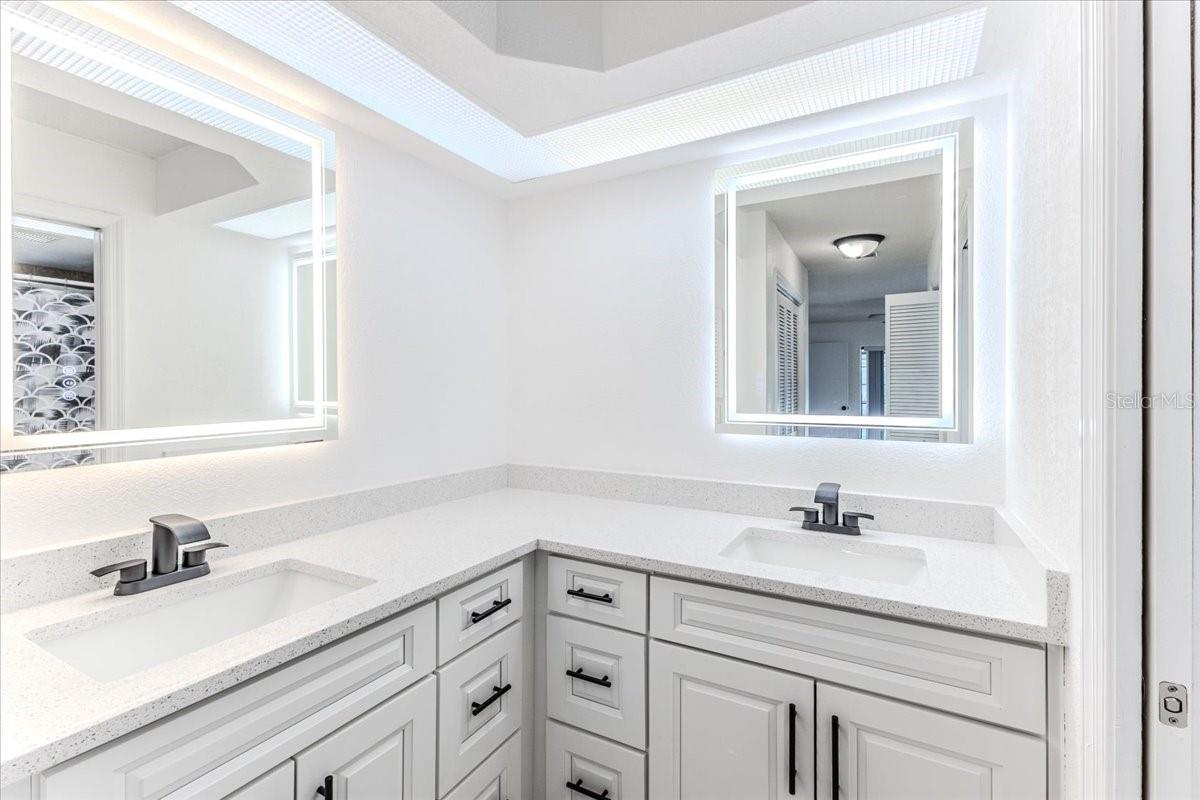 Updated Primary Bathroom with Dual Sinks, Quartz Countertops & LED Vanity Mirrors
