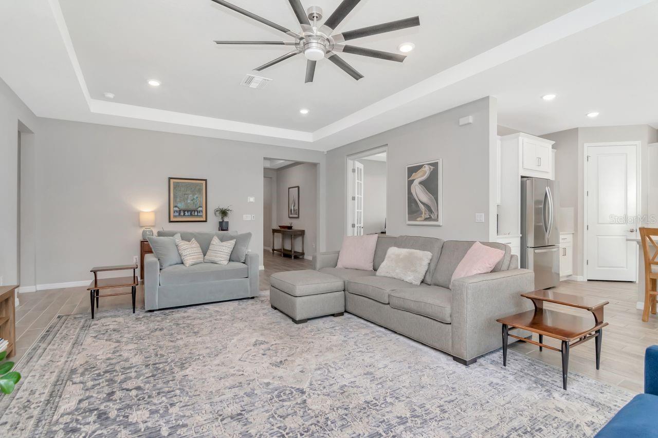 Spacious Livingroom with tray ceiling, upgraded ceiling fan and perfect for entertainin.