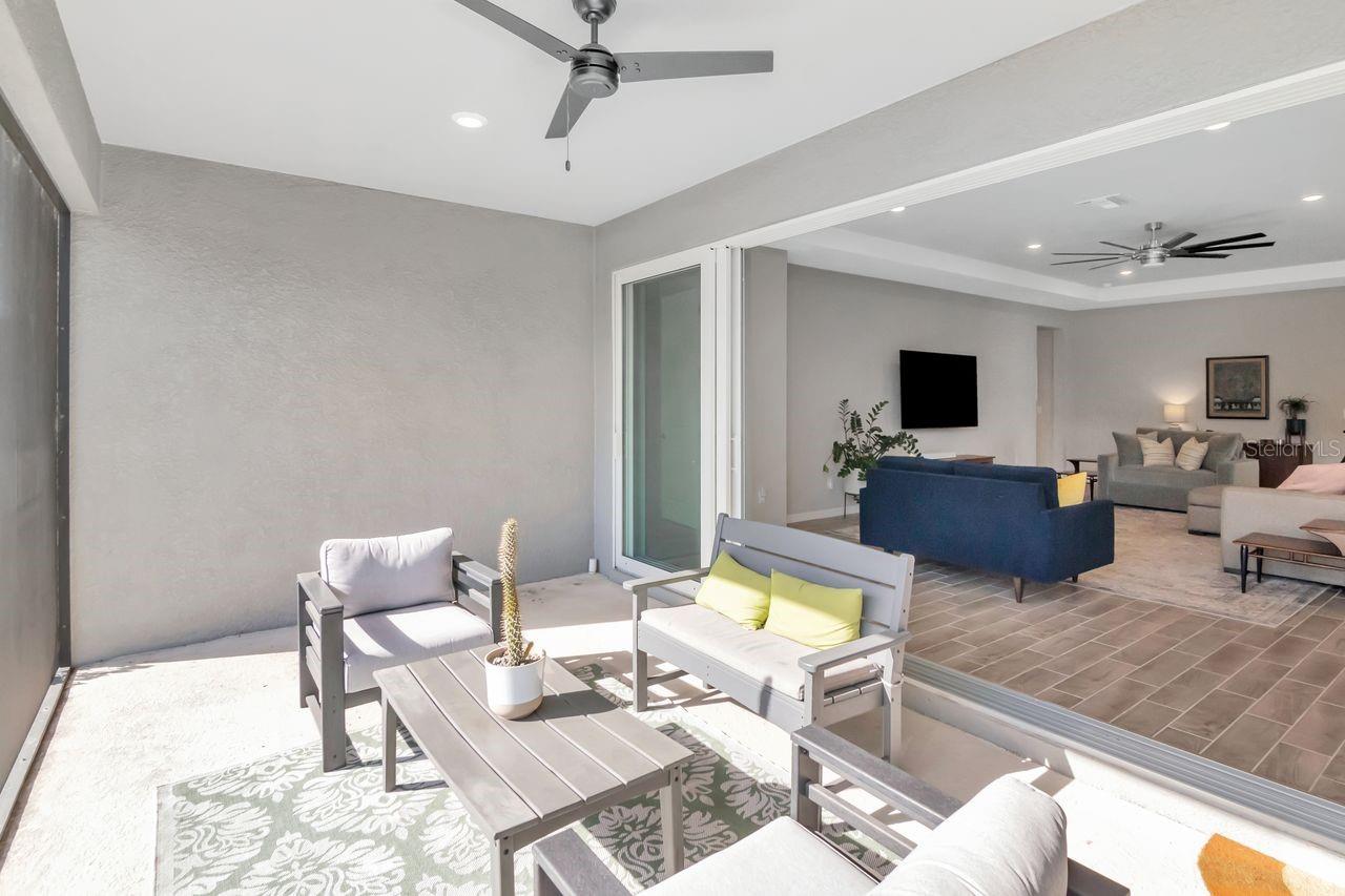 Spacious, screened in lanai with panoramic sliding glass doors