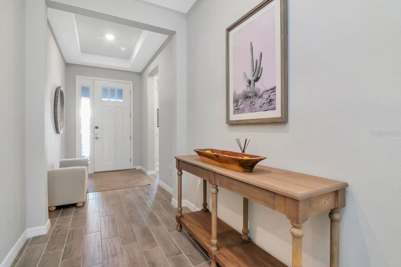 Wide Entrway with double tray ceilings and upgraded front door allowing for natural light.