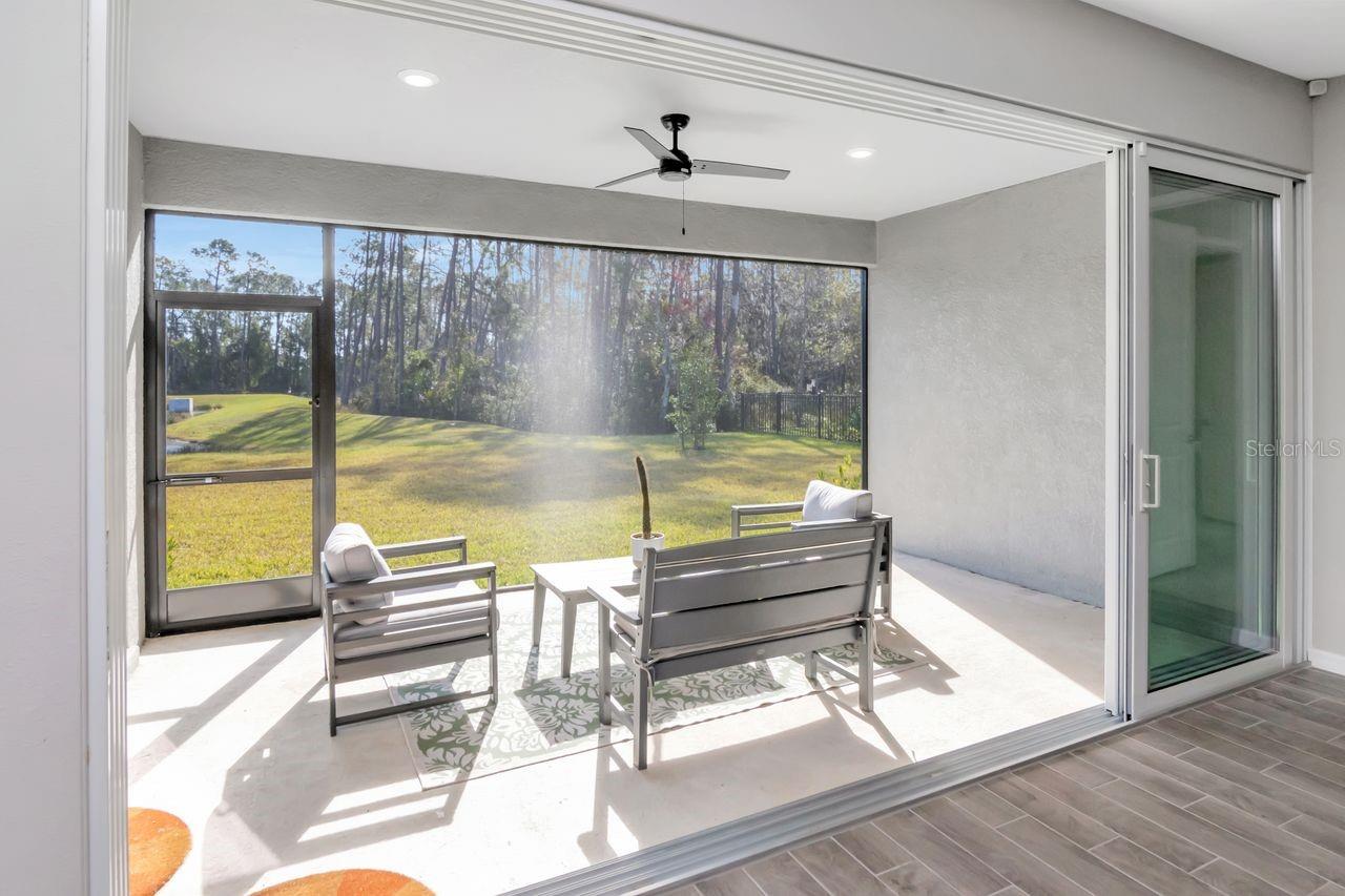 Spacious, screened in lanai with panoramic sliding glass doors