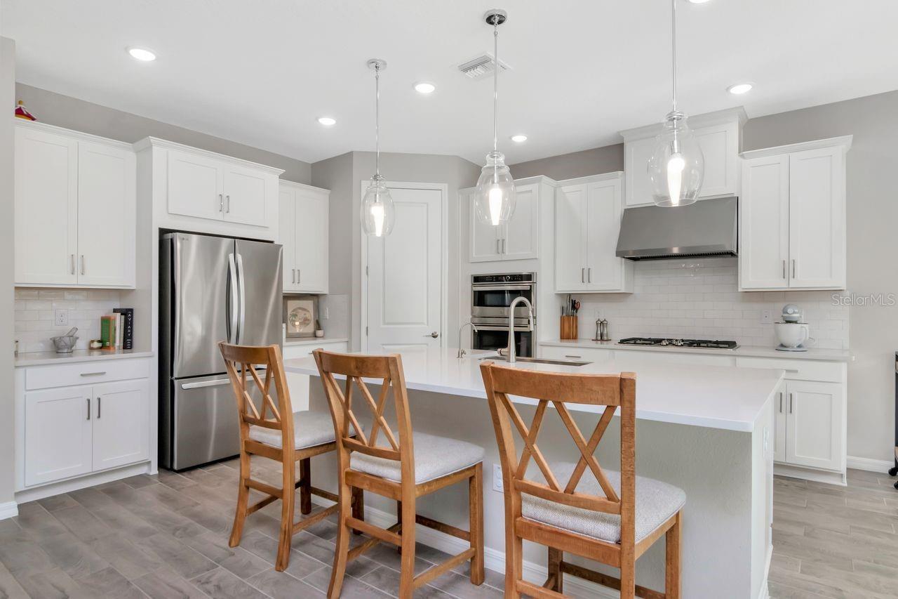 Gourmet Kitchen with large island, stainless steel appliances, upgraded lighting and lots of storage.