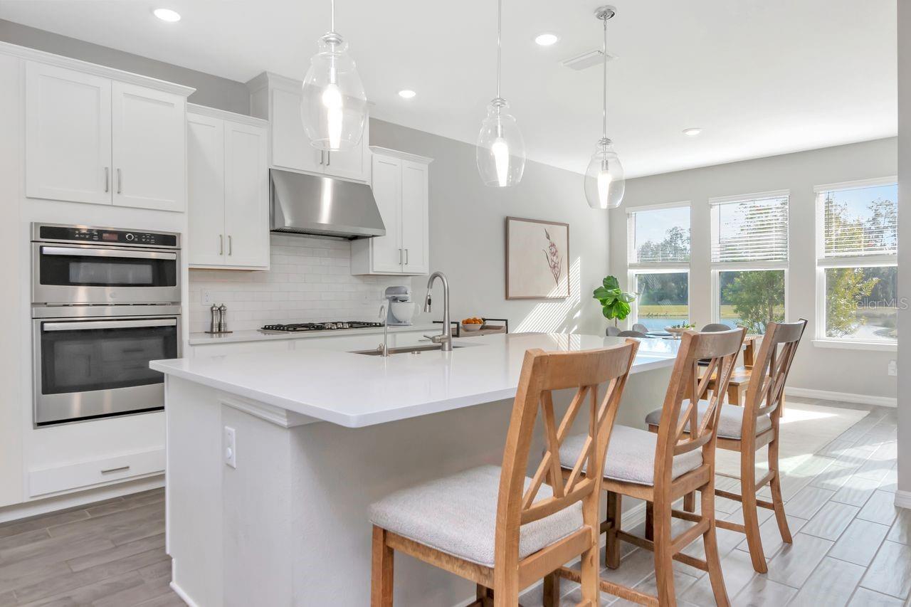 Gourmet Kitchen with large island, stainless steel appliances, upgraded lighting and lots of storage.