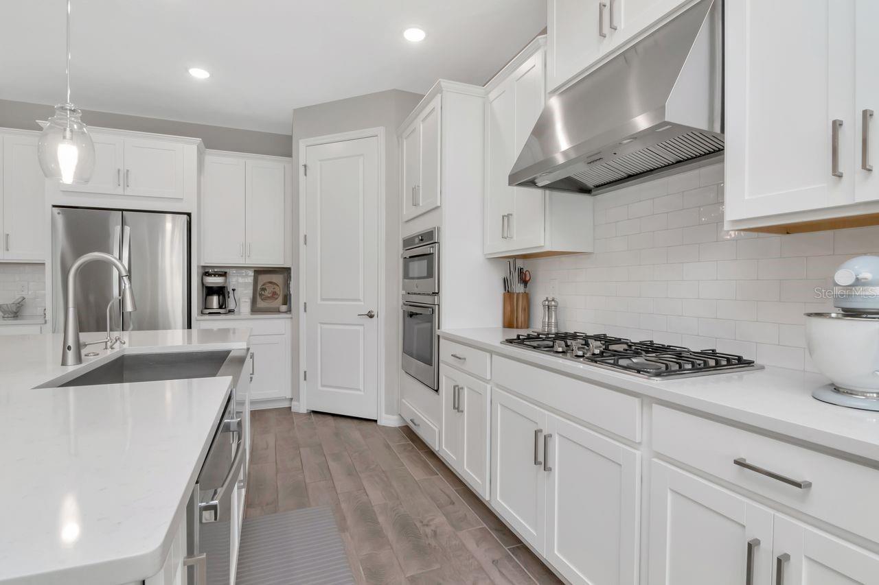 Gourmet Kitchen with large island, stainless steel appliances, upgraded lighting and lots of storage.