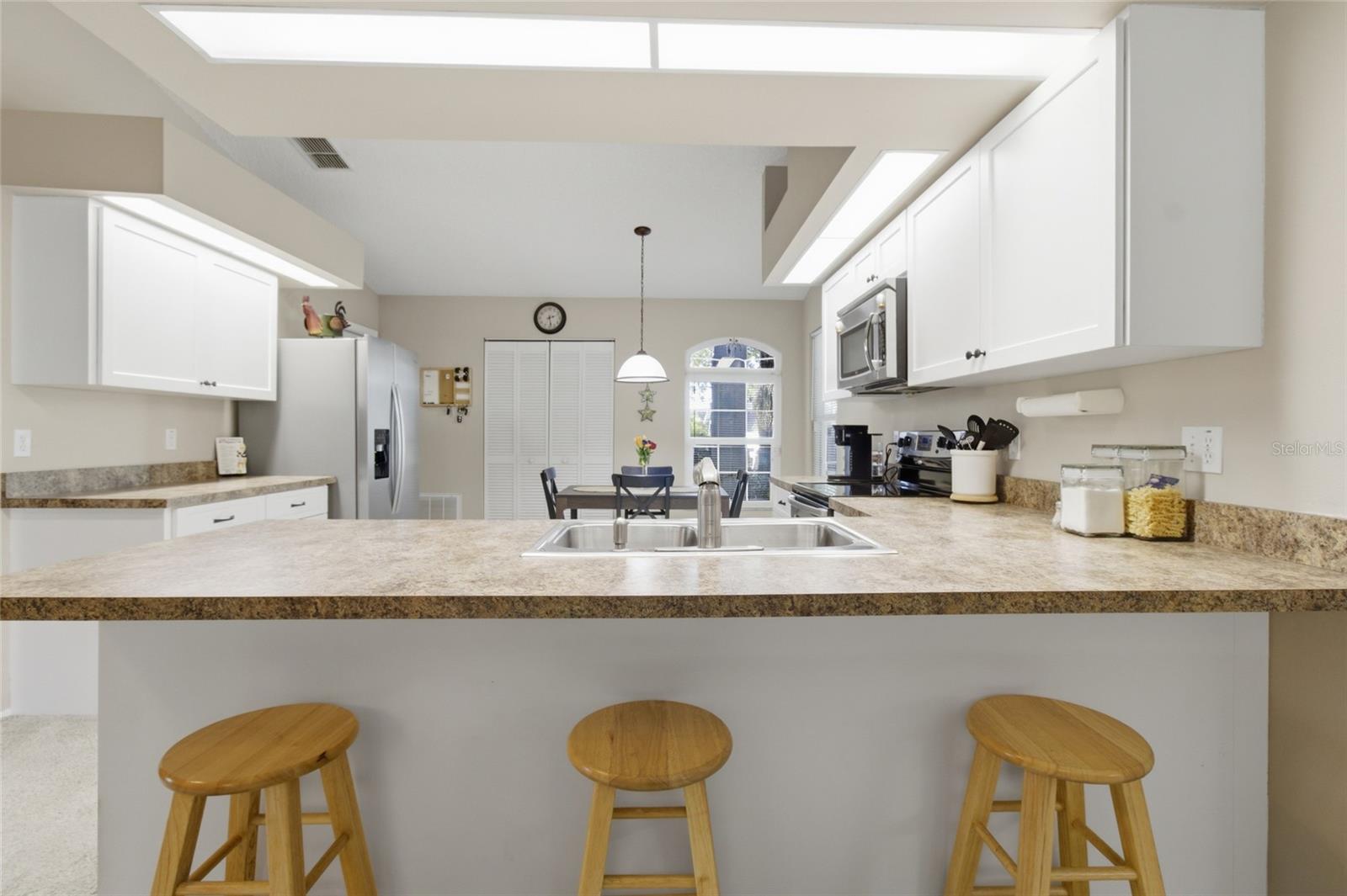 Open Concept Kitchen with Breakfast Bar and Vaulted Ceilings