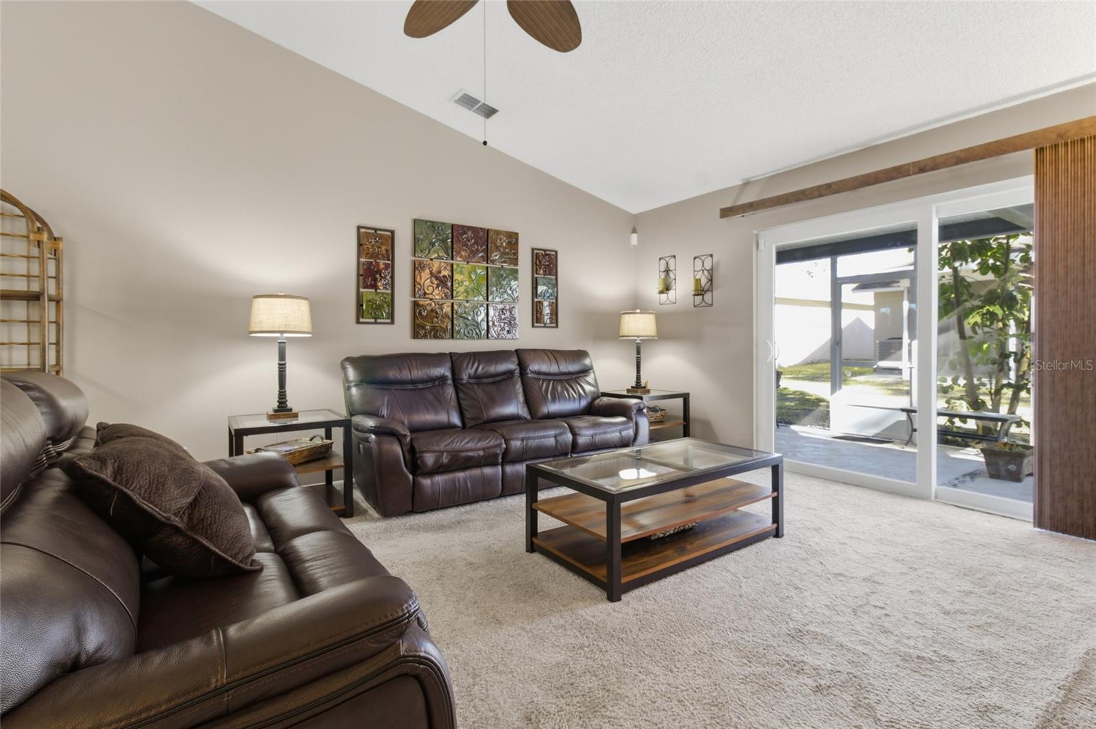 Living Room w/sliders to Pool and Screened Lanai