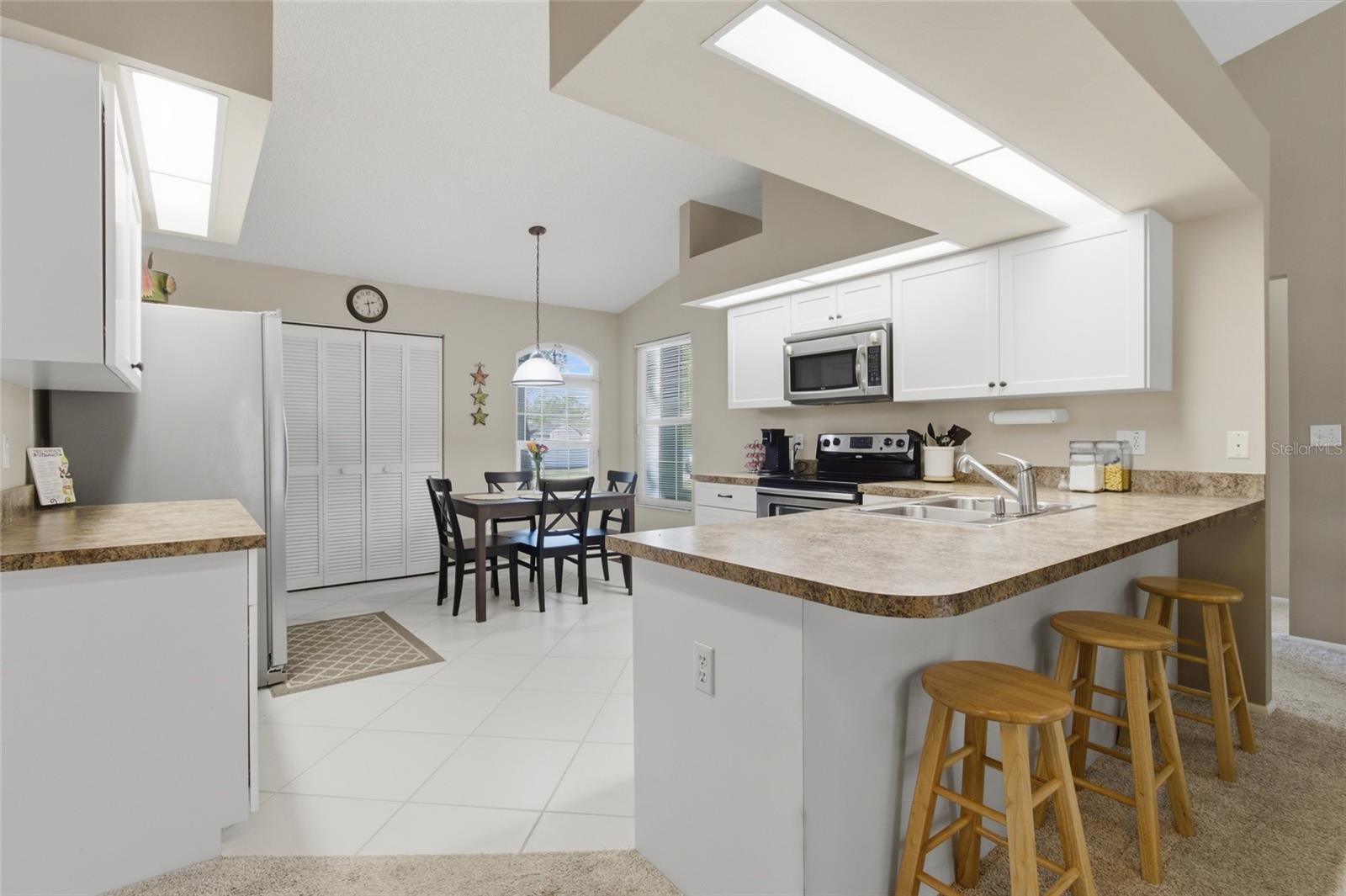 Open Concept Kitchen with Breakfast Bar and Vaulted Ceilings