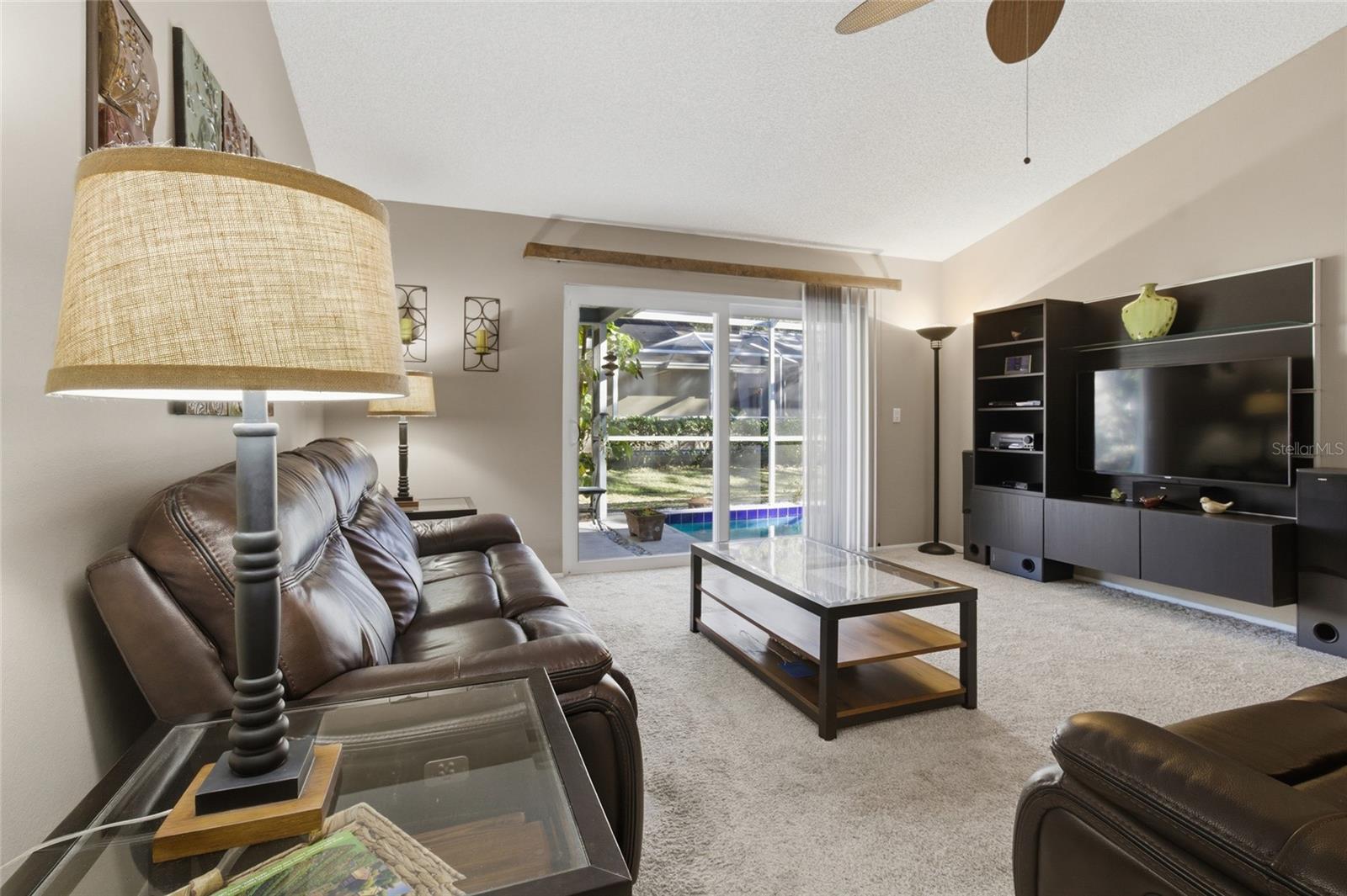 Living Room w/sliders to Pool and Screened Lanai