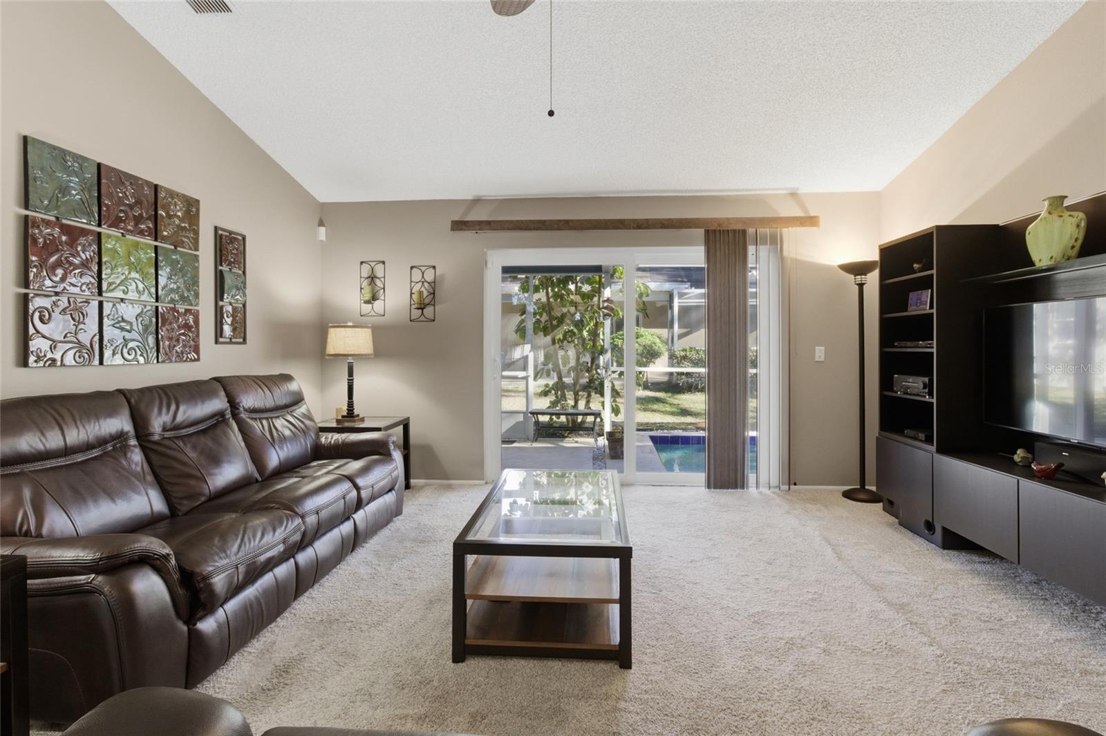Living Room w/sliders to Pool and Screened Lanai