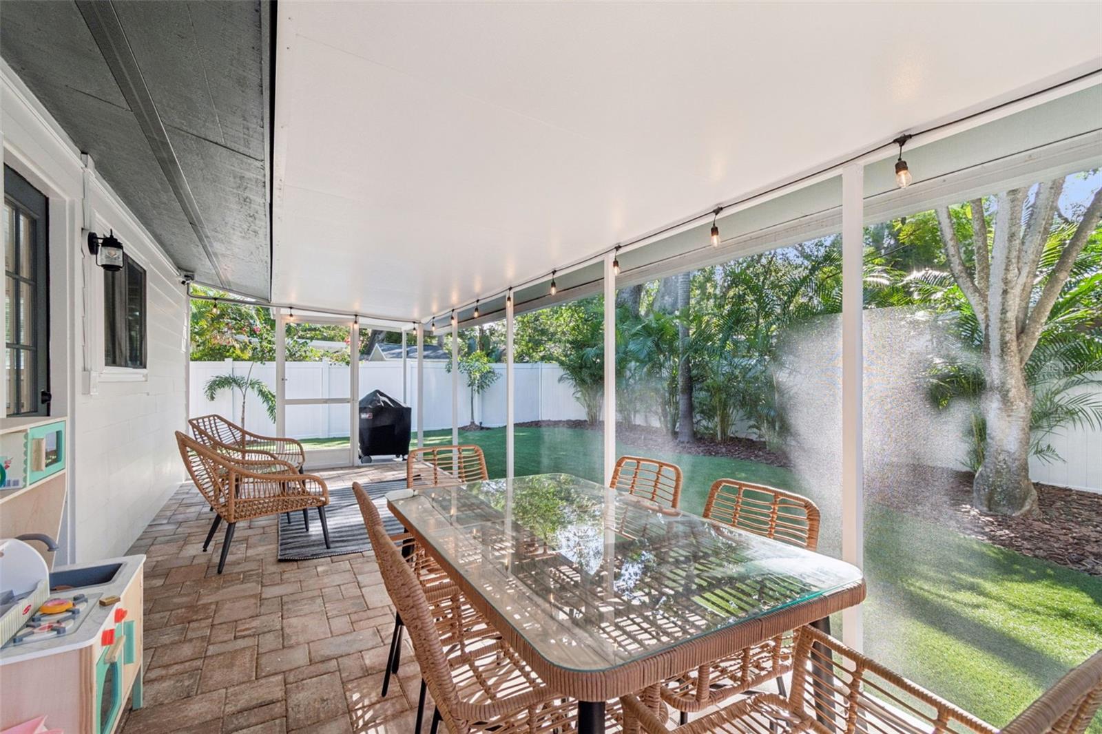 Screened in Lanai w/ Brick Pavers Overlooking the Spacious Turfed Backyard