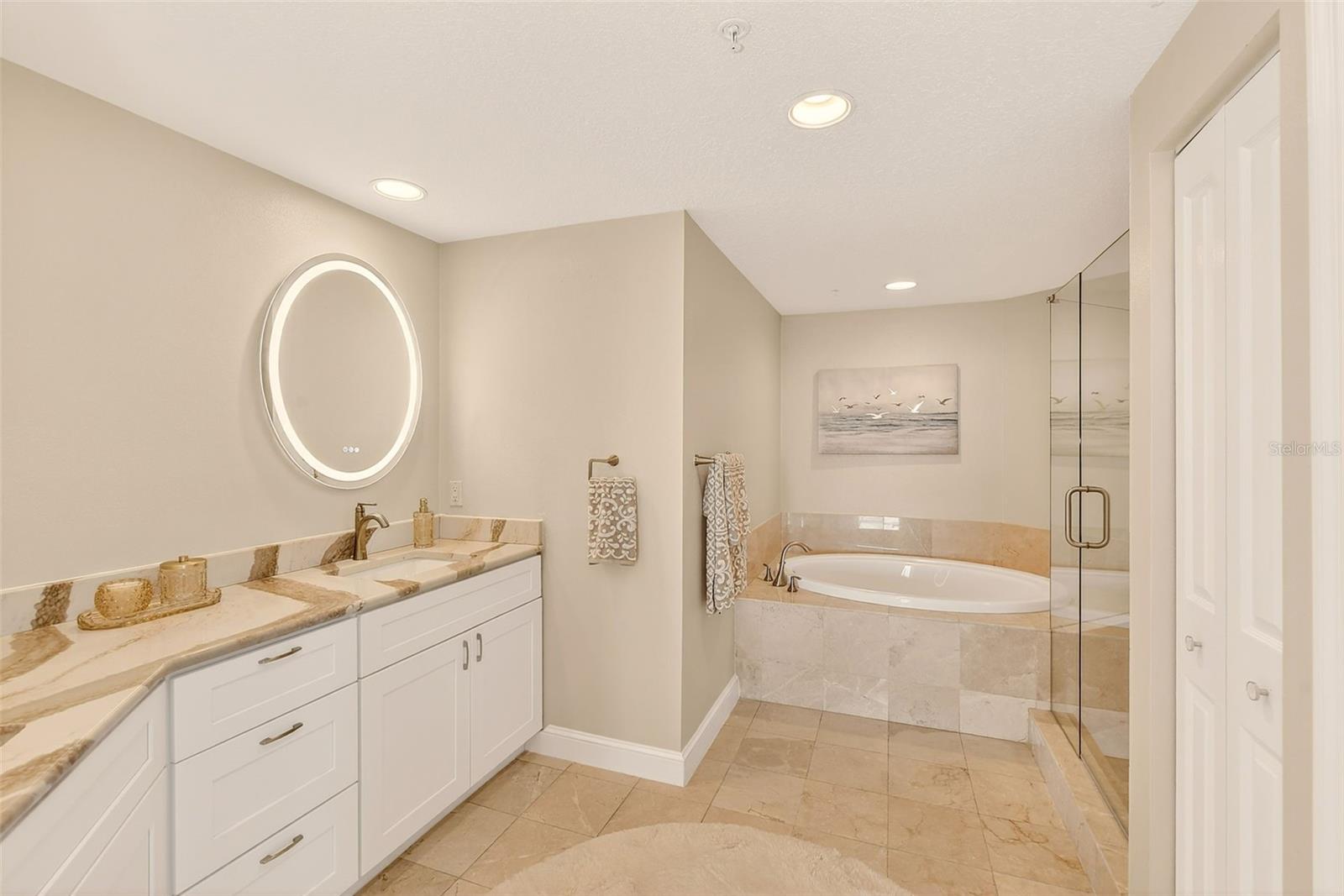 Primary suite: Stunning quartz with double sinks and touch lighted mirrors.