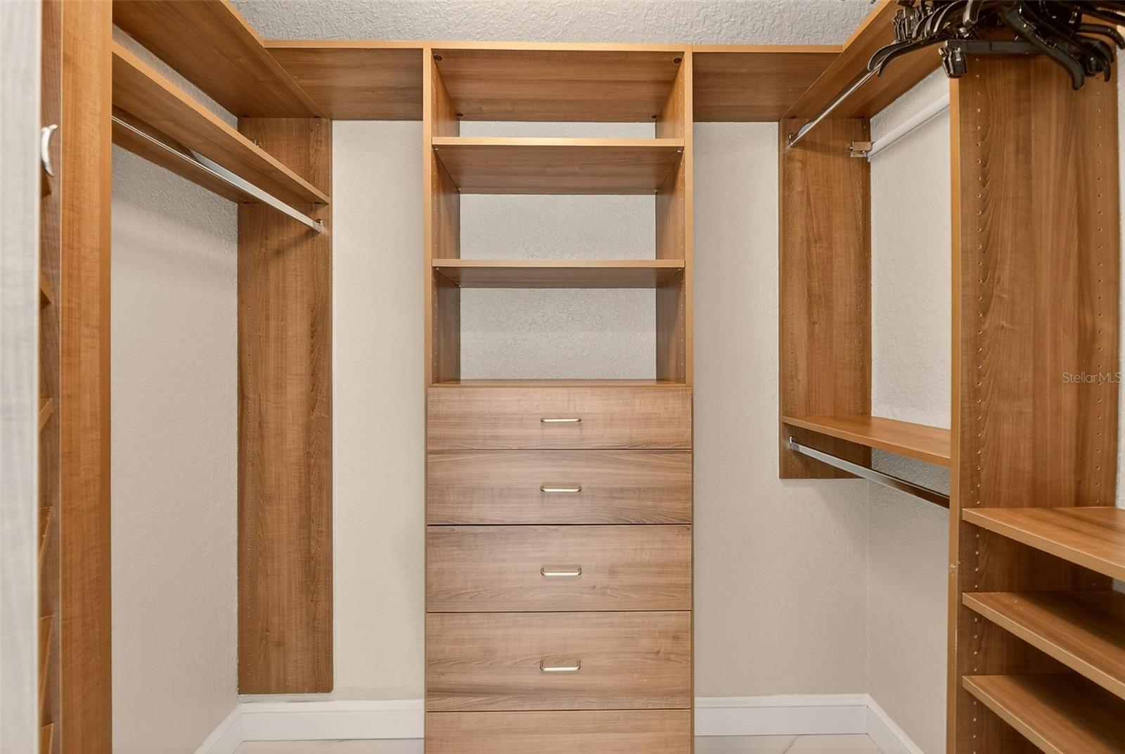 Primary suite: Hers custom built-in closet