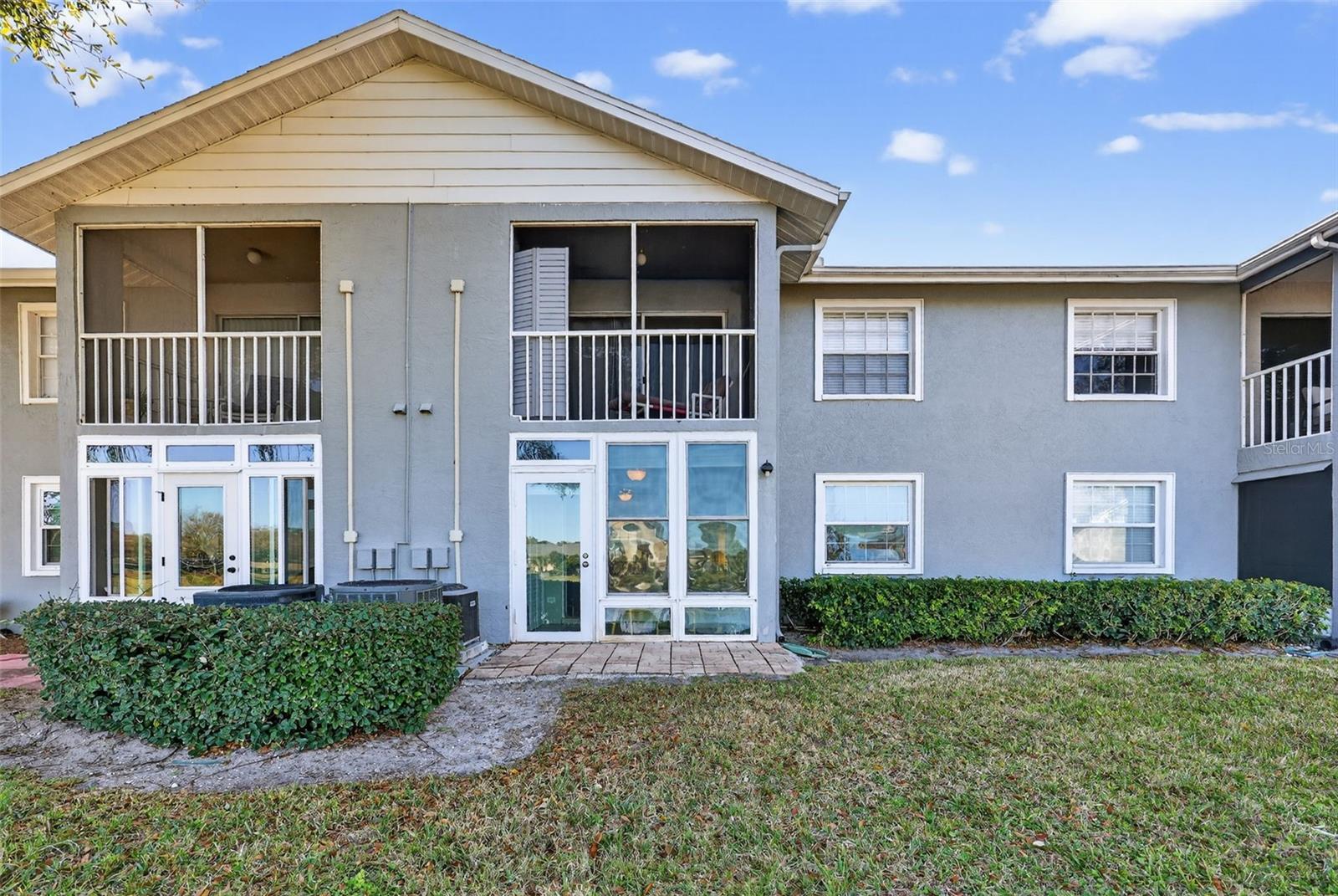 The rear of your home showing the beautiful sunroom, outdoor patio and walking path