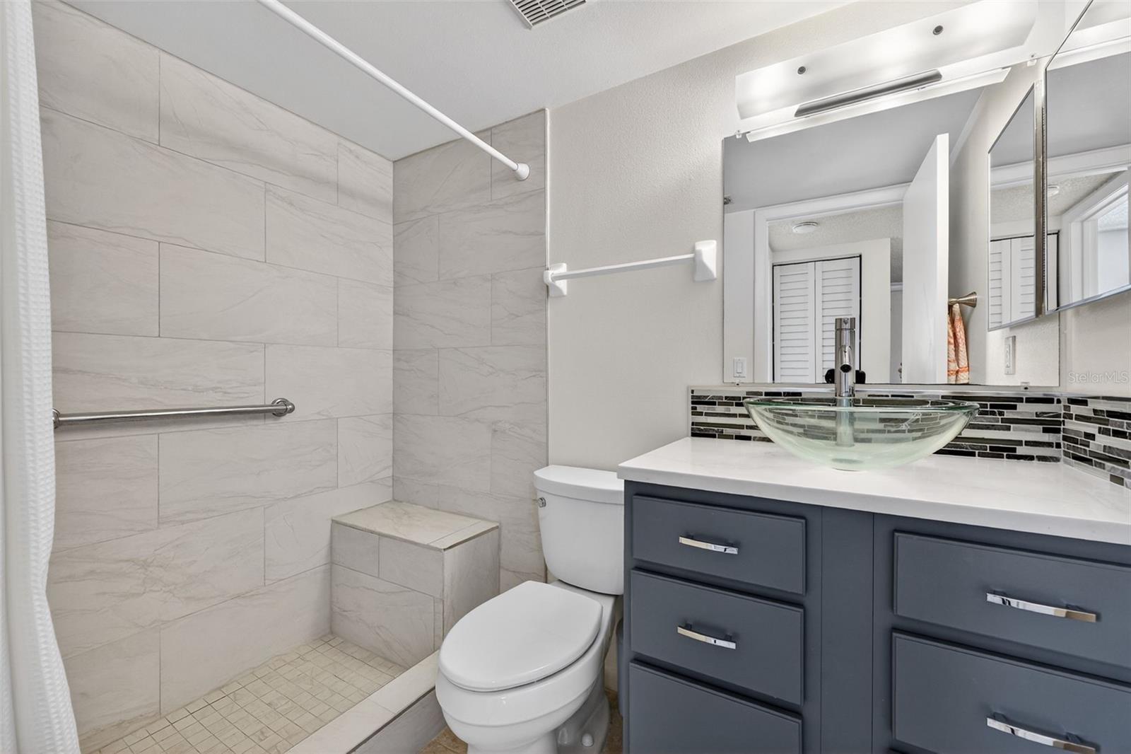 The guest bathroom, has been updated and has a shower with bench seat.
