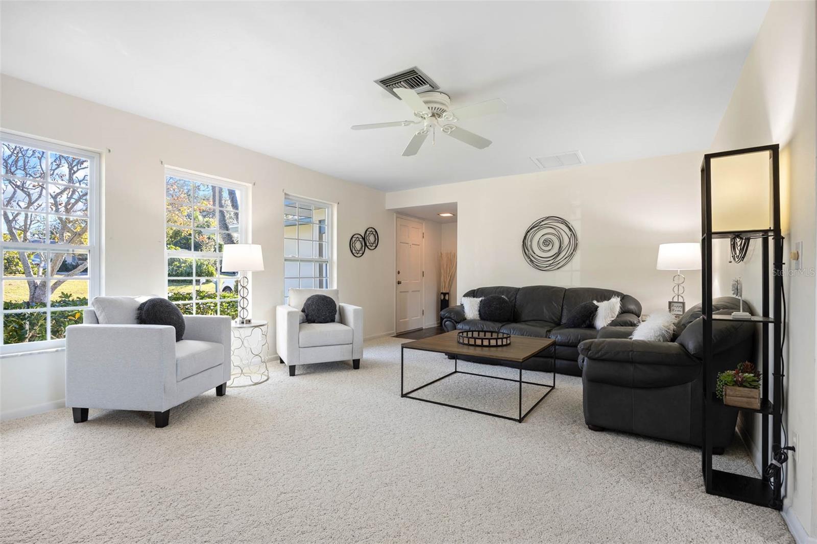 Three large windows fill this Formal Living Room with natural light!