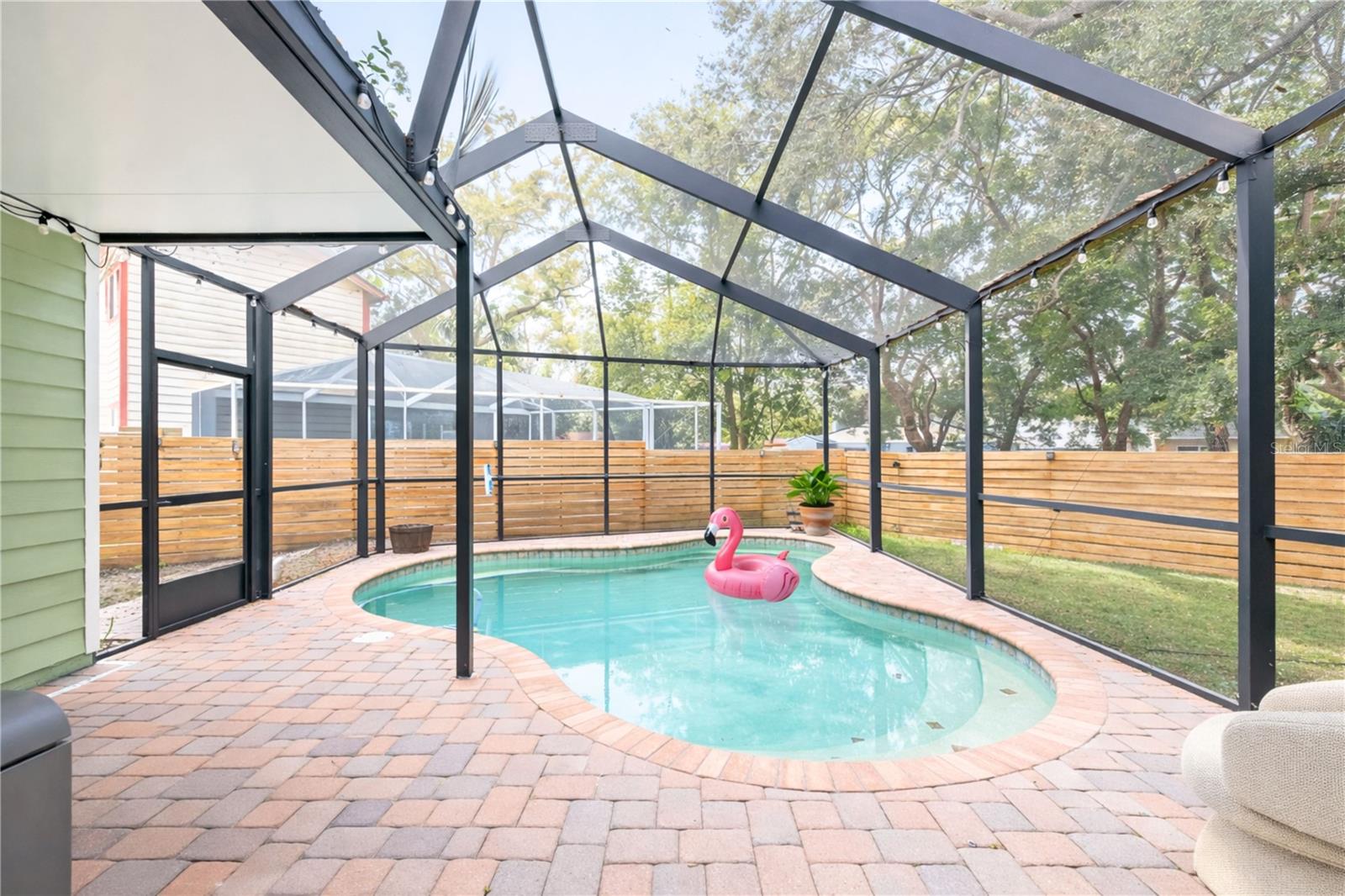 Pavered Patio next to Caged Pool