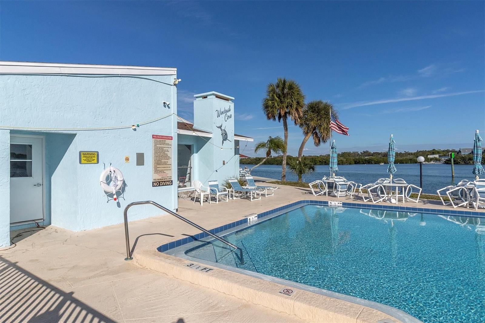Community Pool with lots of seating and water views