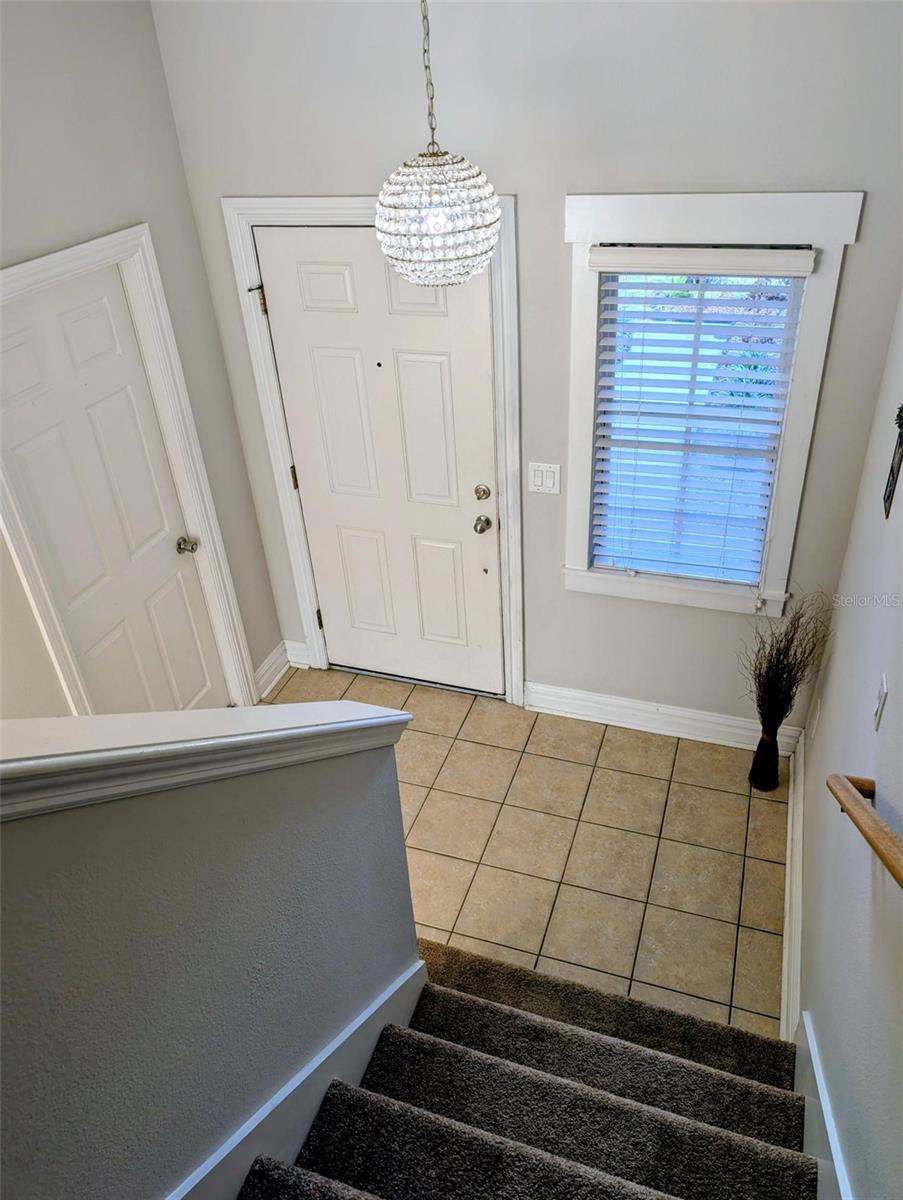 Stairs and entrance with beautiful light fixture