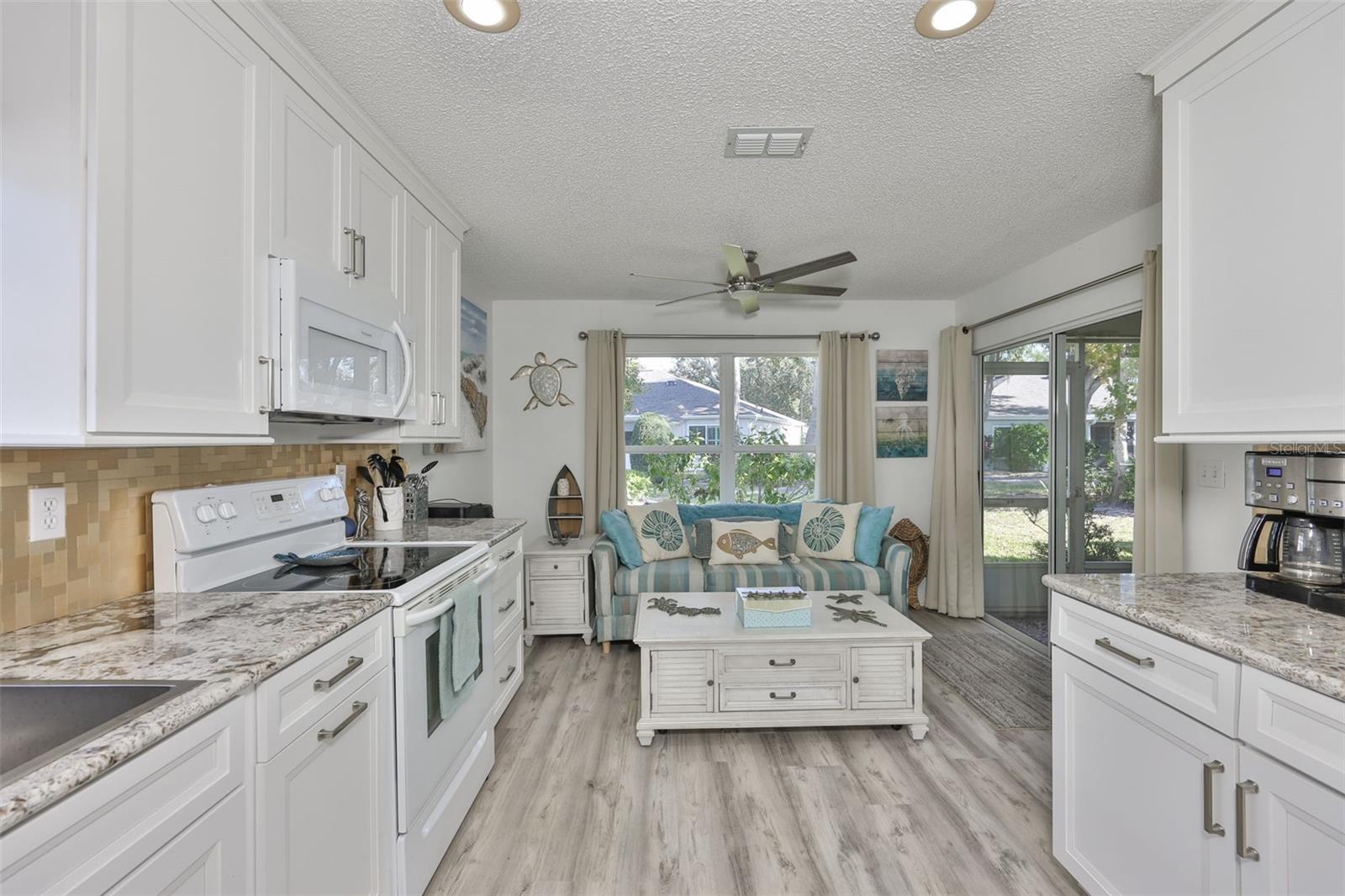 Kitchen looking into a den