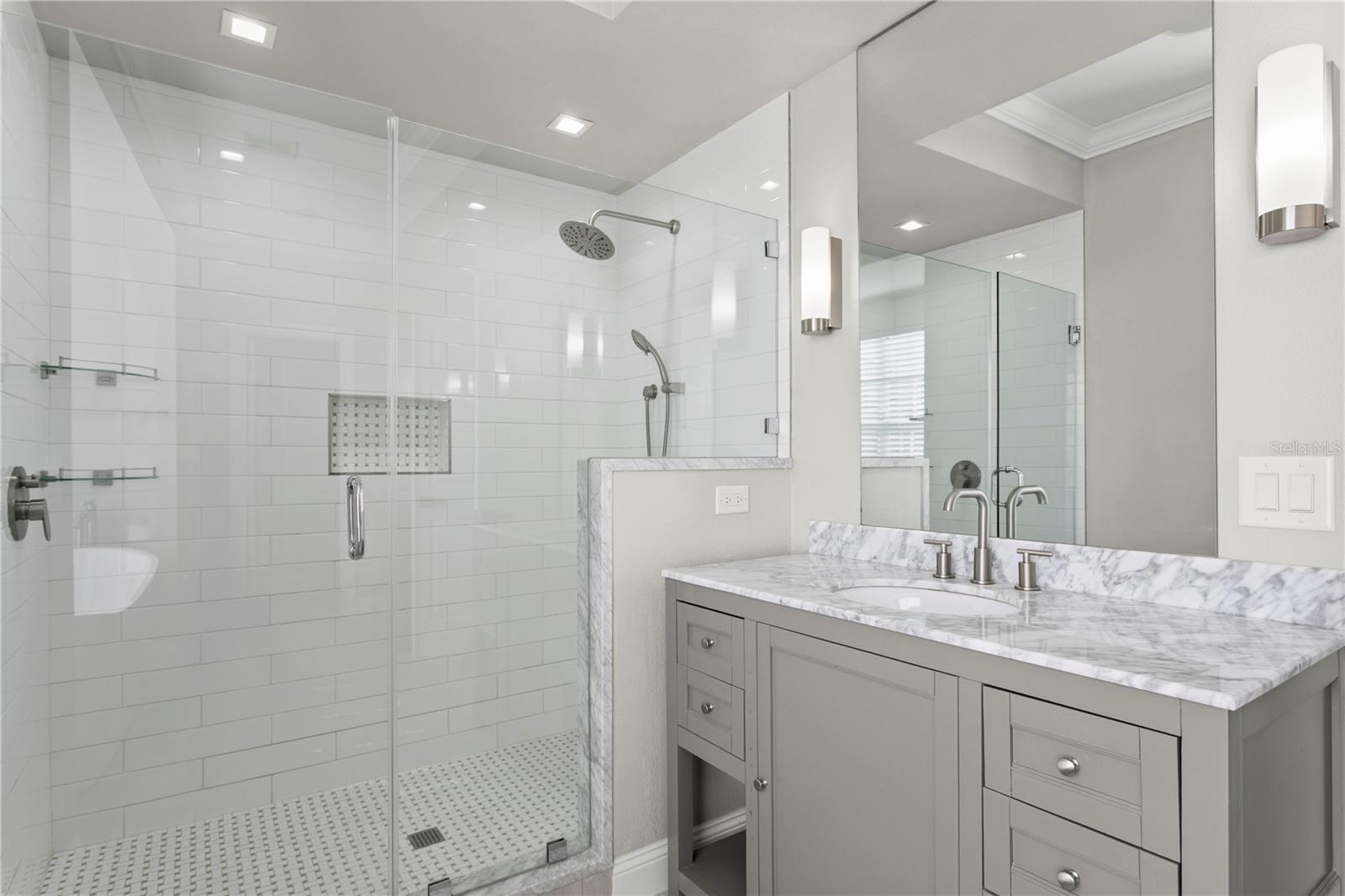The primary en suite bath is a true retreat, featuring a large soaking tub, walk-in shower, dual vanities, and a separate water closet.