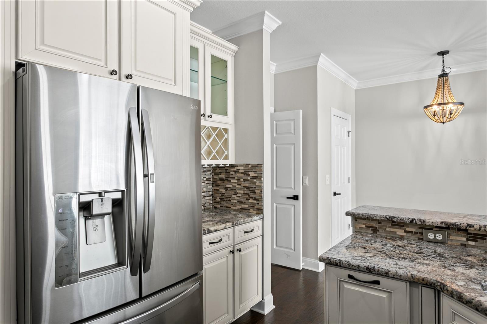 Updated kitchen with stainless steel appliances, dedicated wine storage, and ample countertop space for easy prep and entertaining.