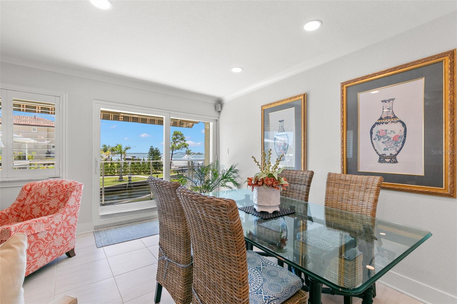 Well-defined dining space featuring recessed lighting and clean architectural lines, seamlessly connected to the living area and outdoor balcony.