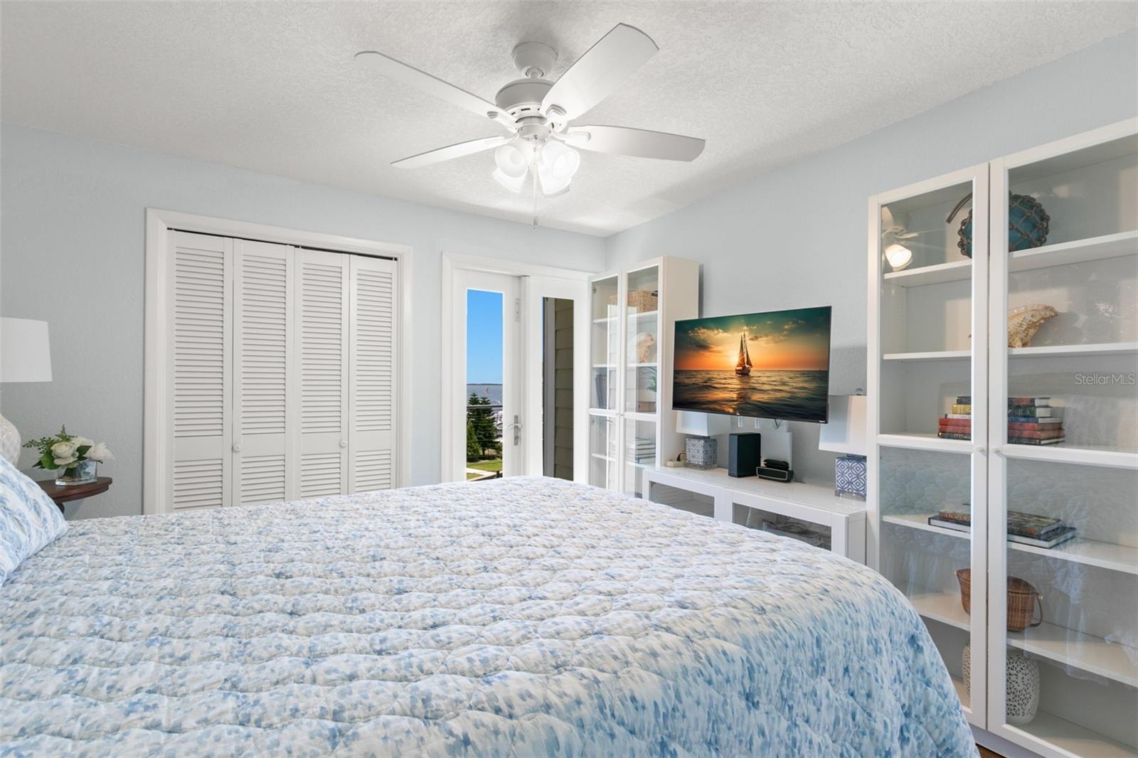 Alternate view highlighting generous closet space, abundant natural light, and direct access to the balcony for indoor-outdoor living.