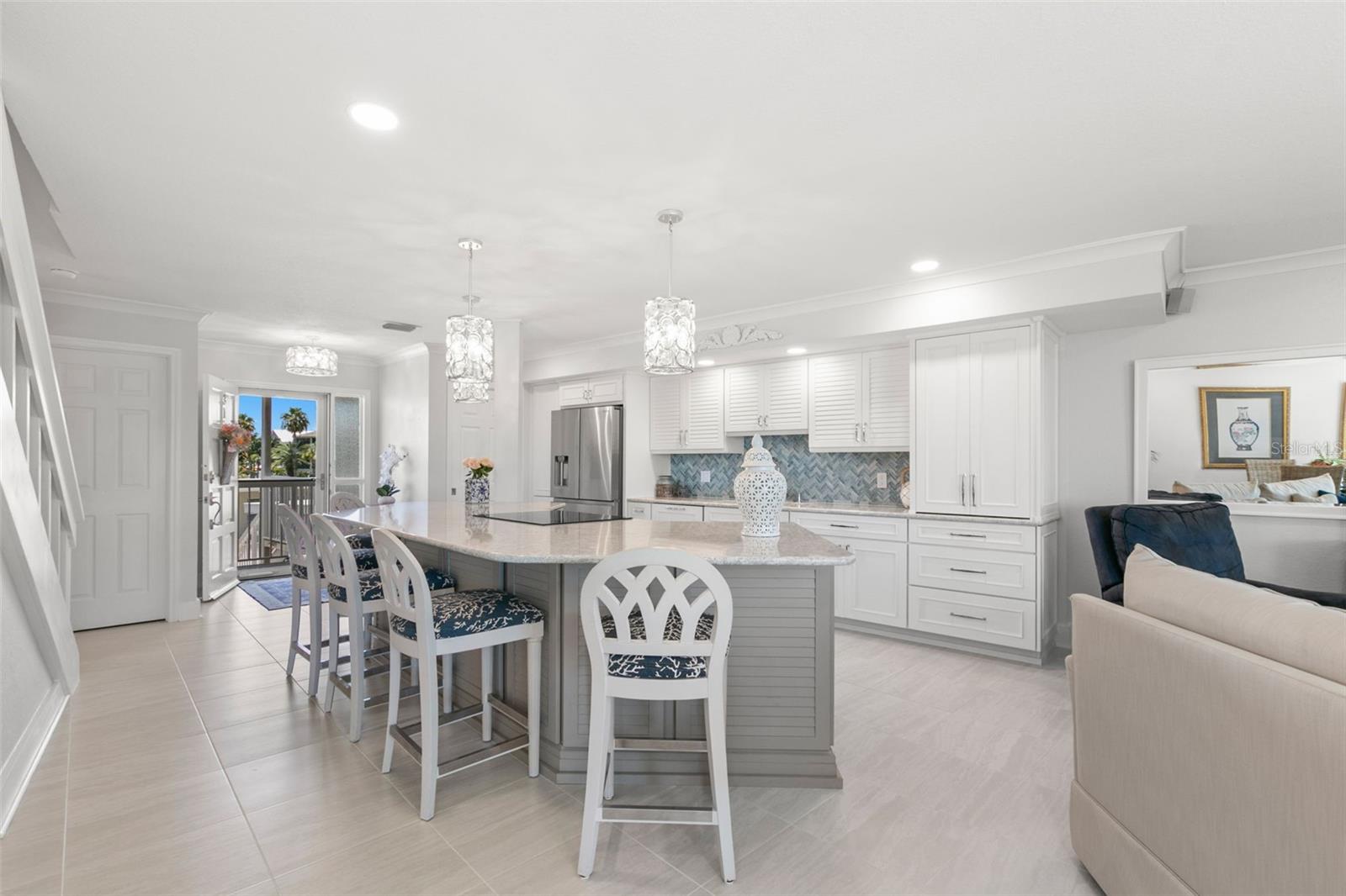Seamless connection between kitchen and living areas, with stylish pendant lighting, neutral flooring, and an easy flow ideal for everyday living or entertaining.