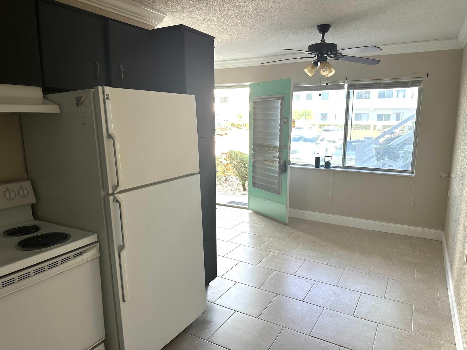 VIEW FROM THE KITCHEN LOOKING PAST THE DINING ROOM TO THE FRONT DOOR