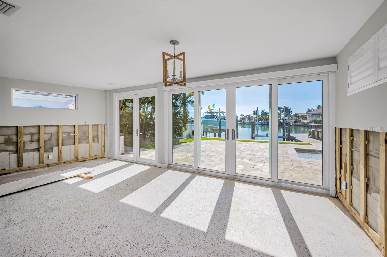 Primary bedroom with beautiful views of pool and water.