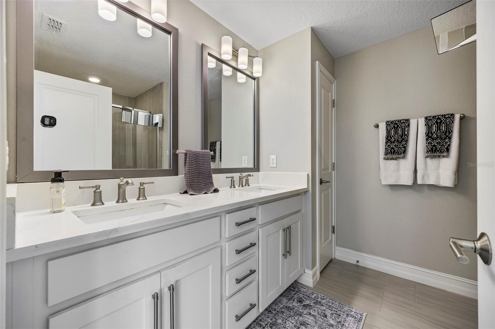 Dual sinks with quartz counters and shaker style cabinets