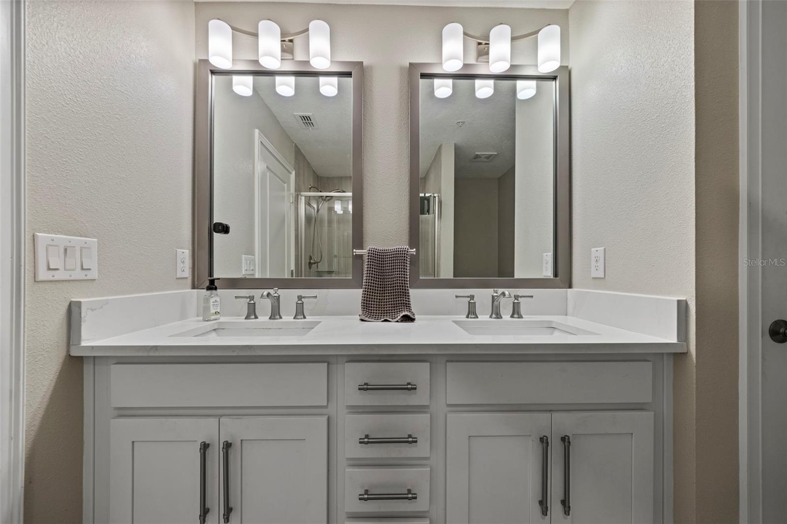 Dual sinks with quartz counters and shaker style cabinets