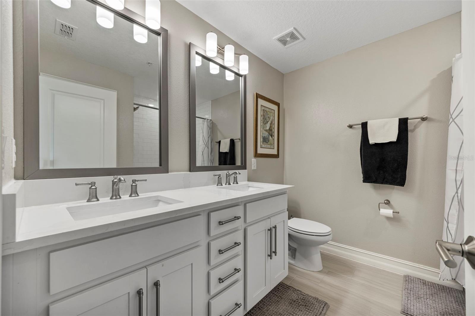 Dual sinks with quartz counters and shaker style cabinets