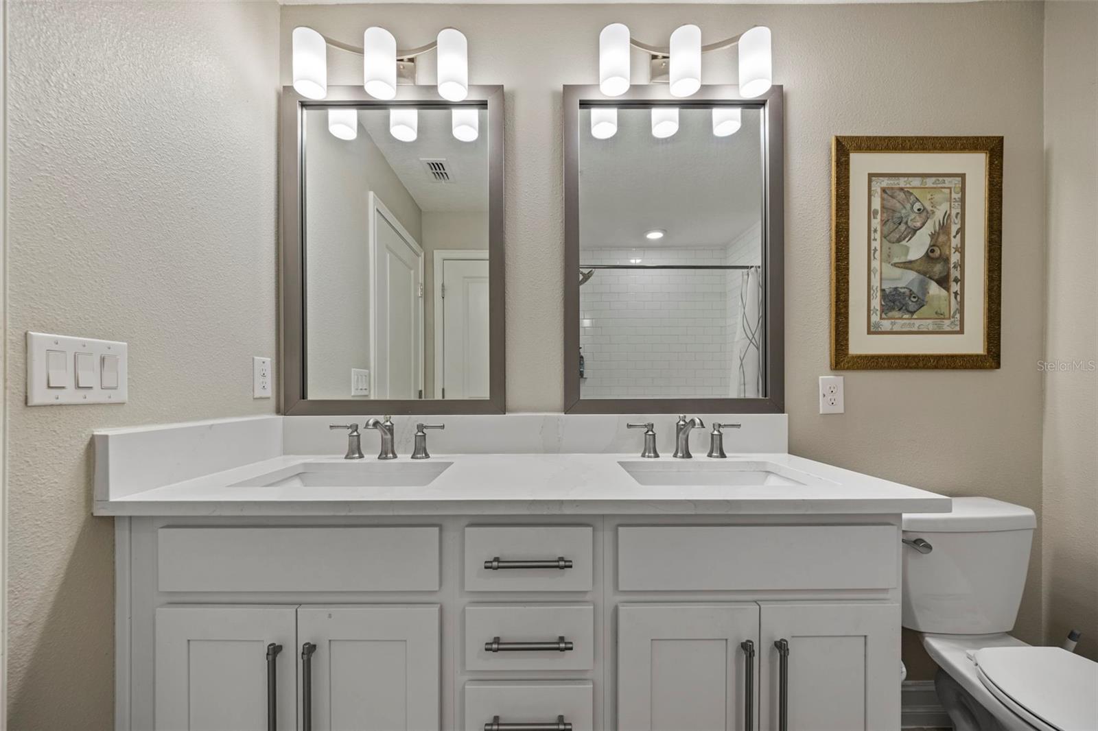 Dual sinks with quartz counters and shaker style cabinets