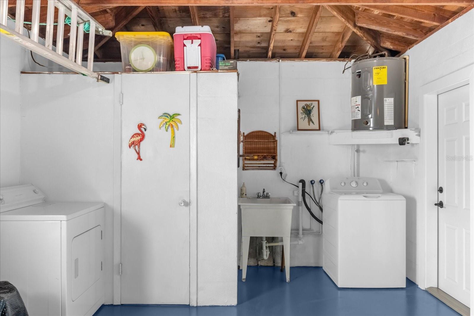 Garage with 1/2 bath, washer/dryer and a convenient washtub