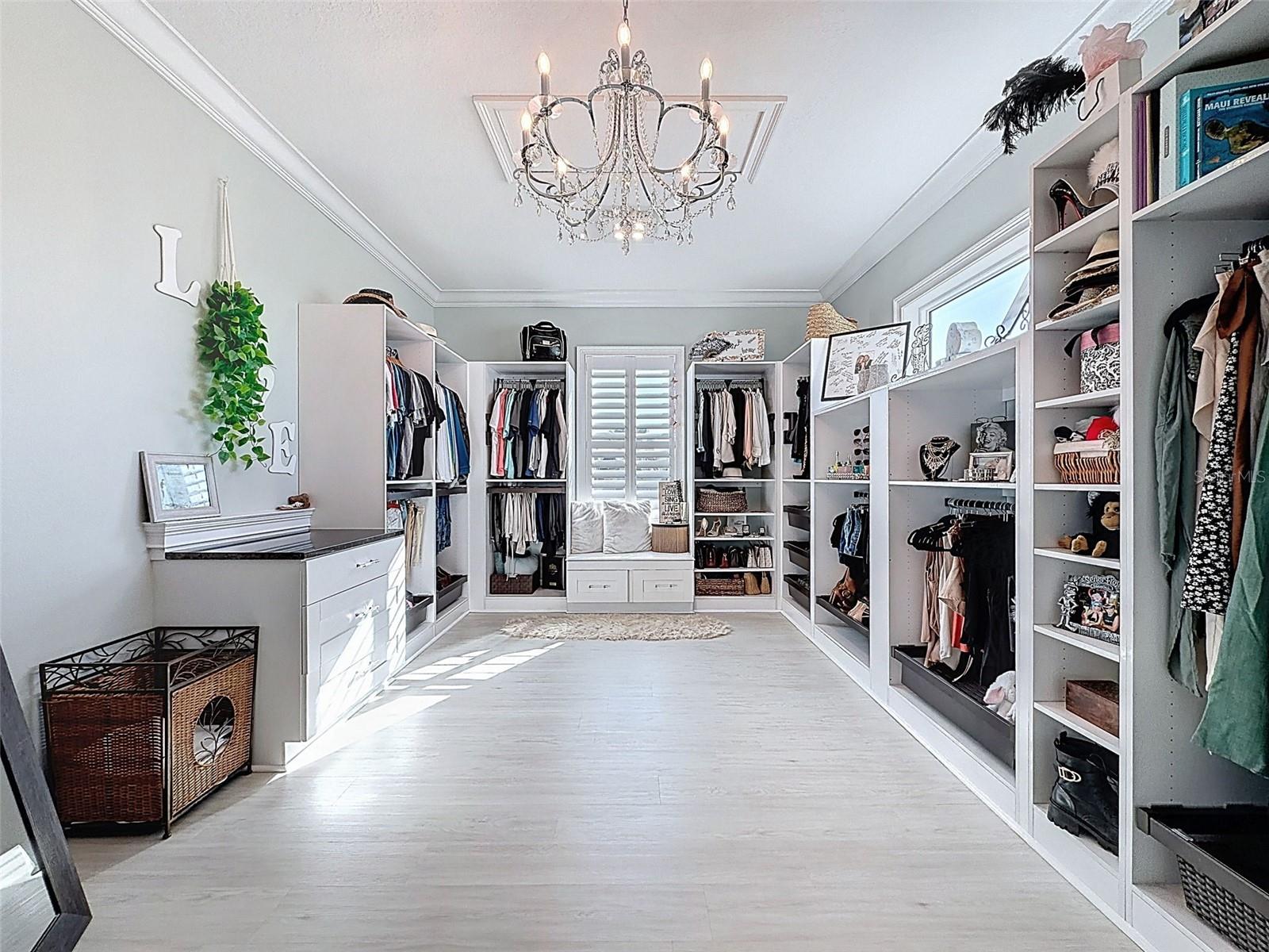 oversized custom walk-in closet filled with natural light.