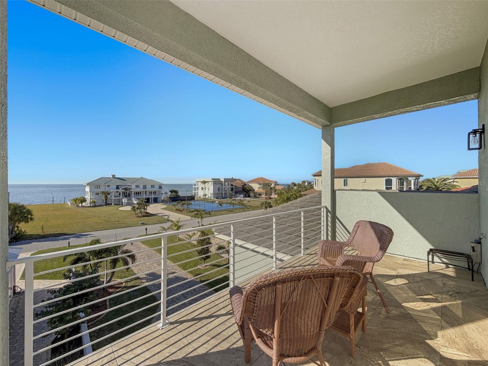 balcony with panoramic Gulf water views.