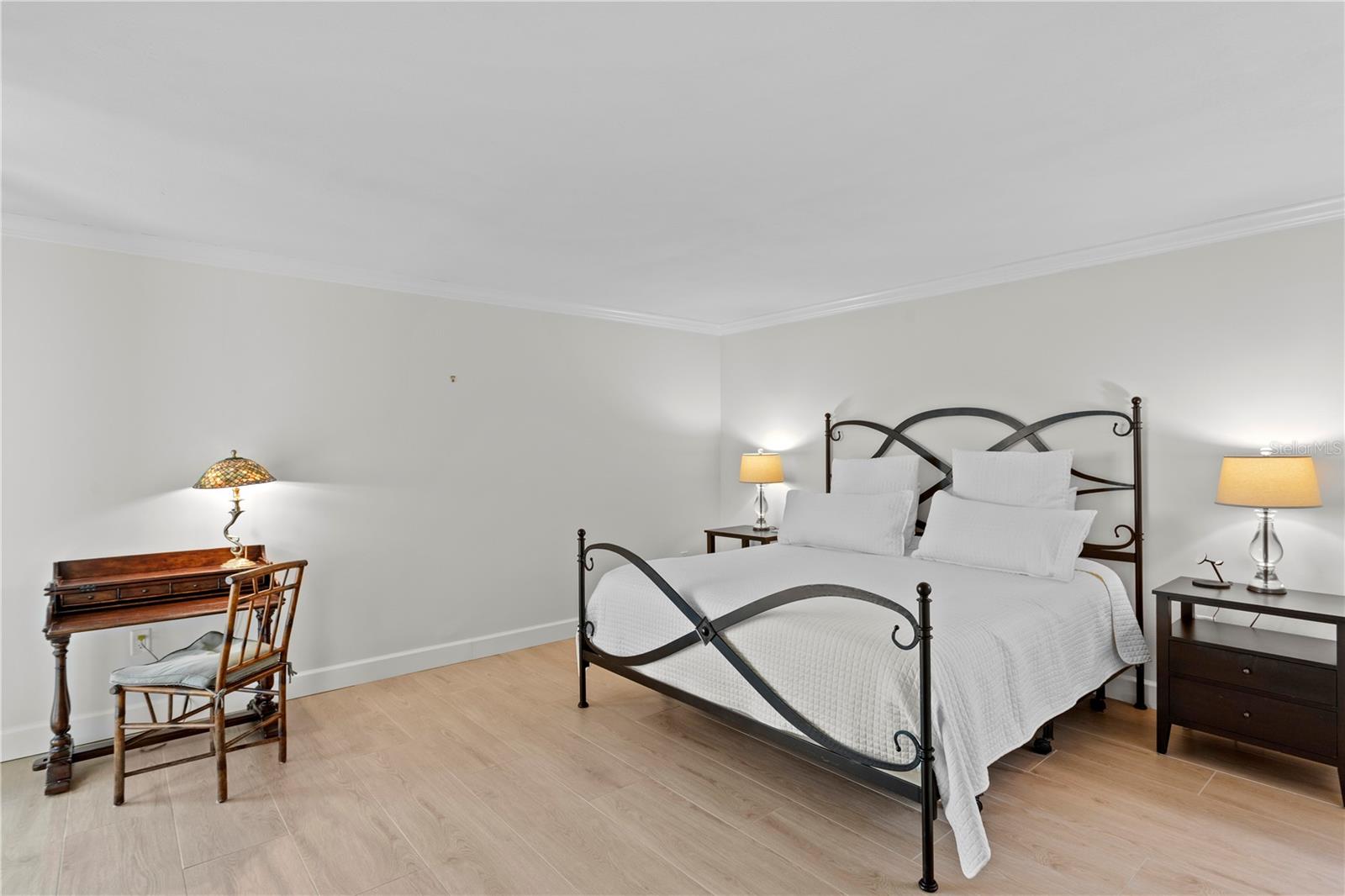 The spacious primary suite features terrace access and uninterrupted Bay views.