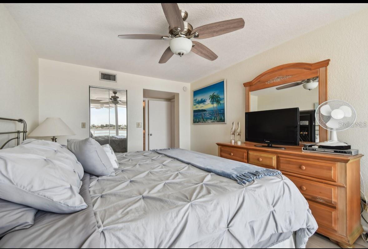 primary bedroom looking towards entry door,  walk in closet and primary bathroom