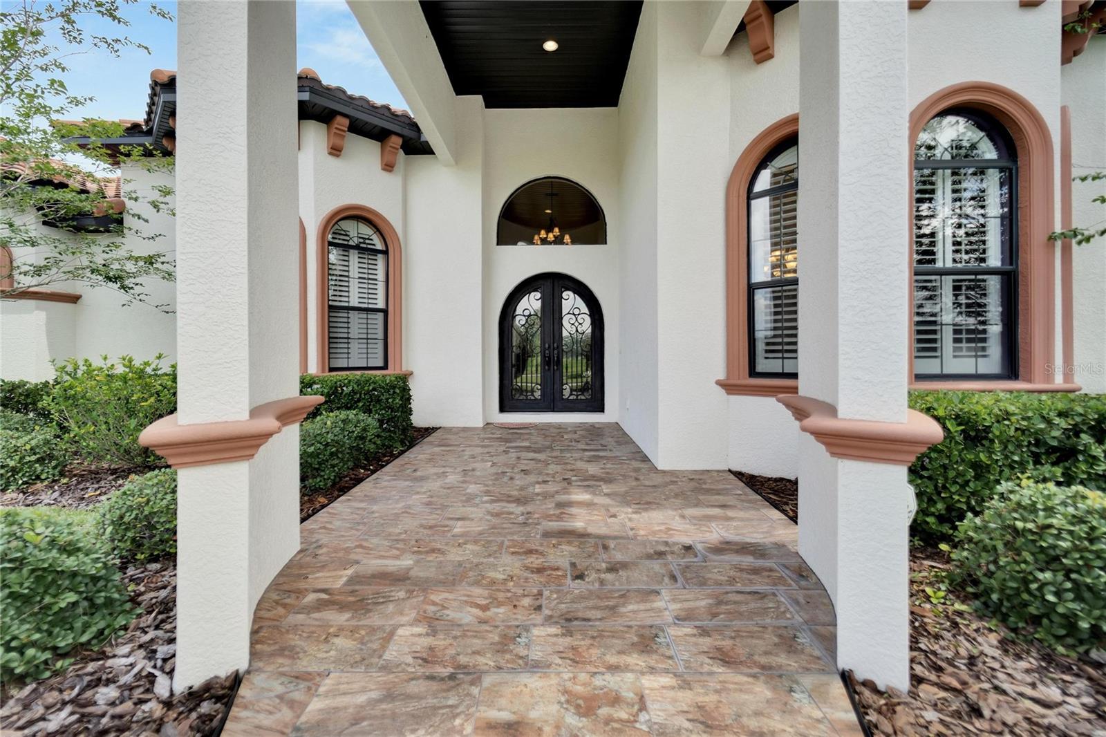 Grand Entry with Double Wood Iron Front Doors