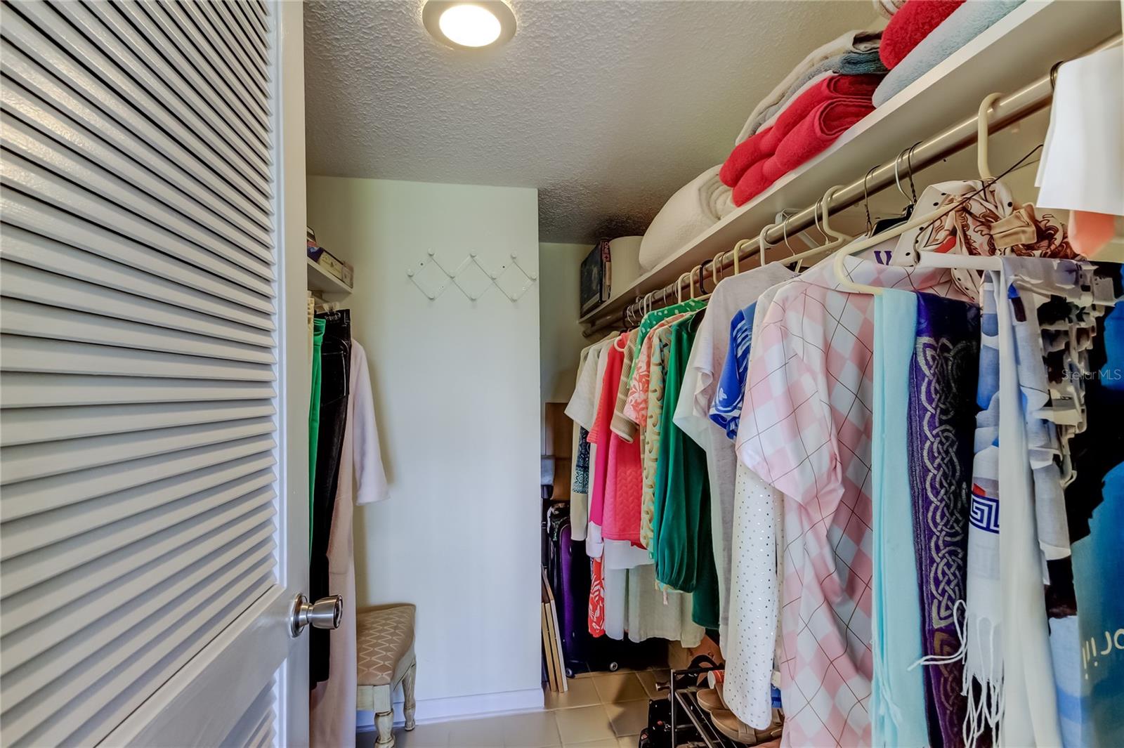 Primary bedroom walk in closet