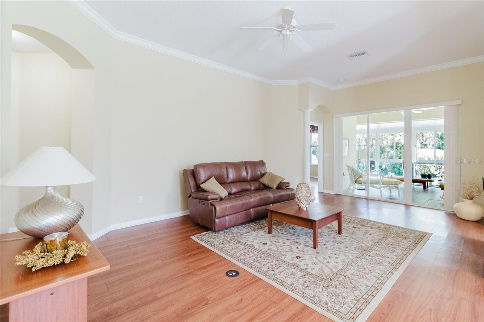 Spacious living room with high ceilings and crown molding