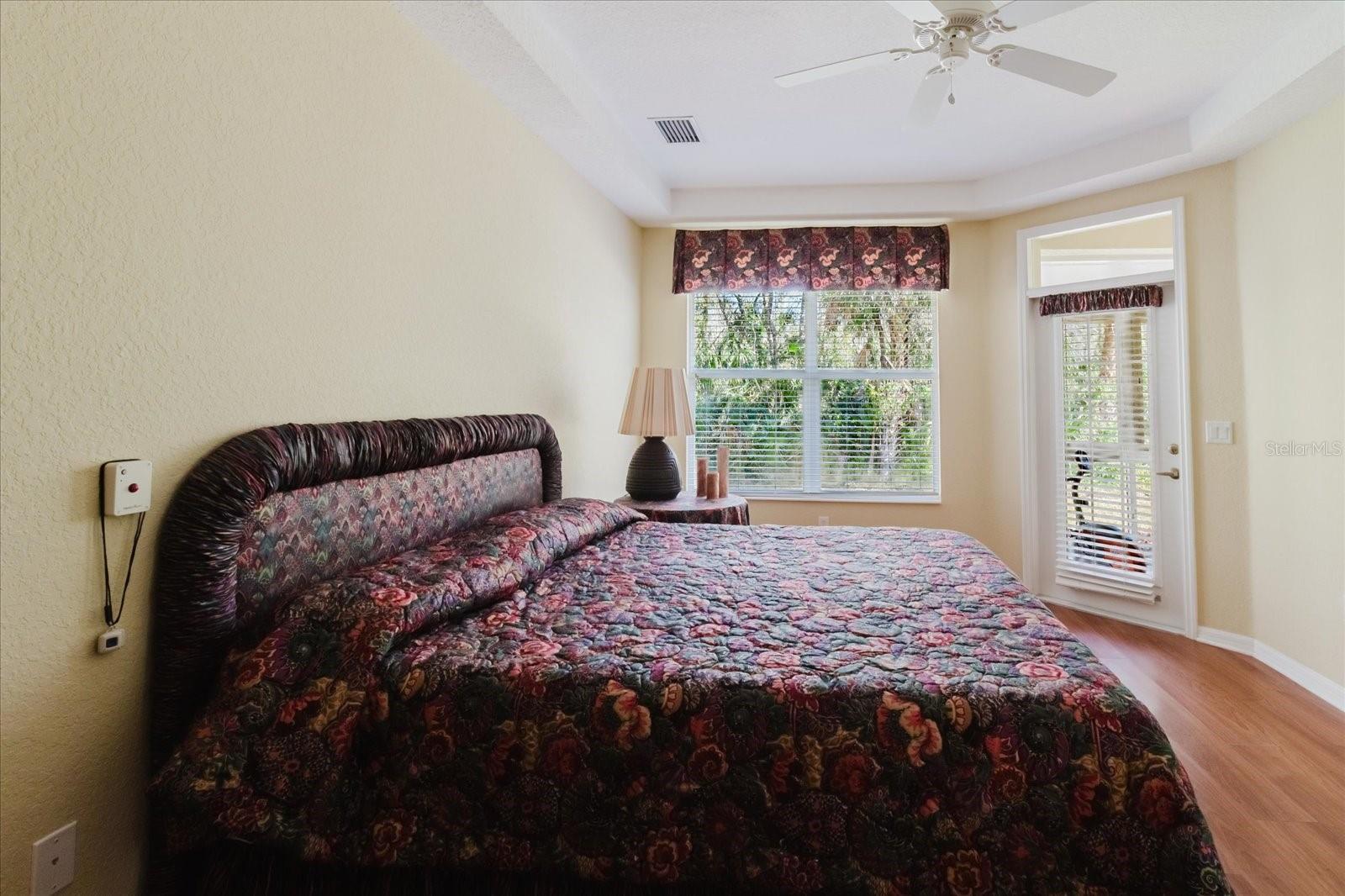 Primary Suite with emergency button next to bed on wall