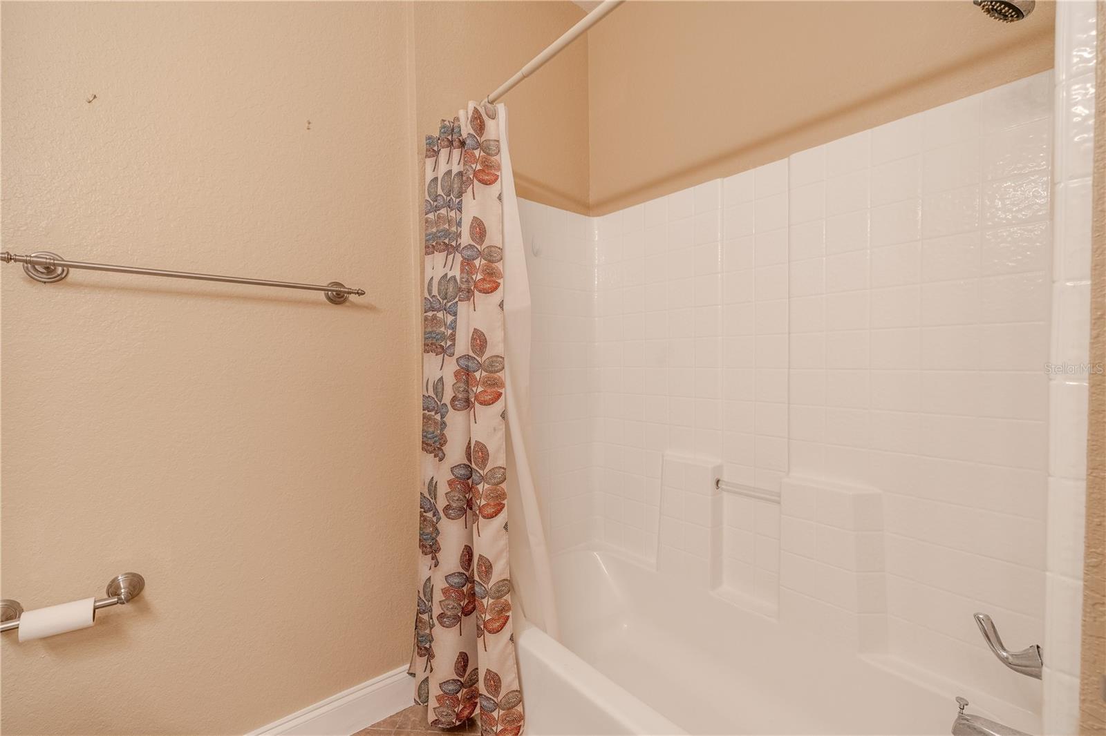 2nd bath/shower combo includes a surround and neutral finishes, offering a clean, functional space for guests or everyday use.