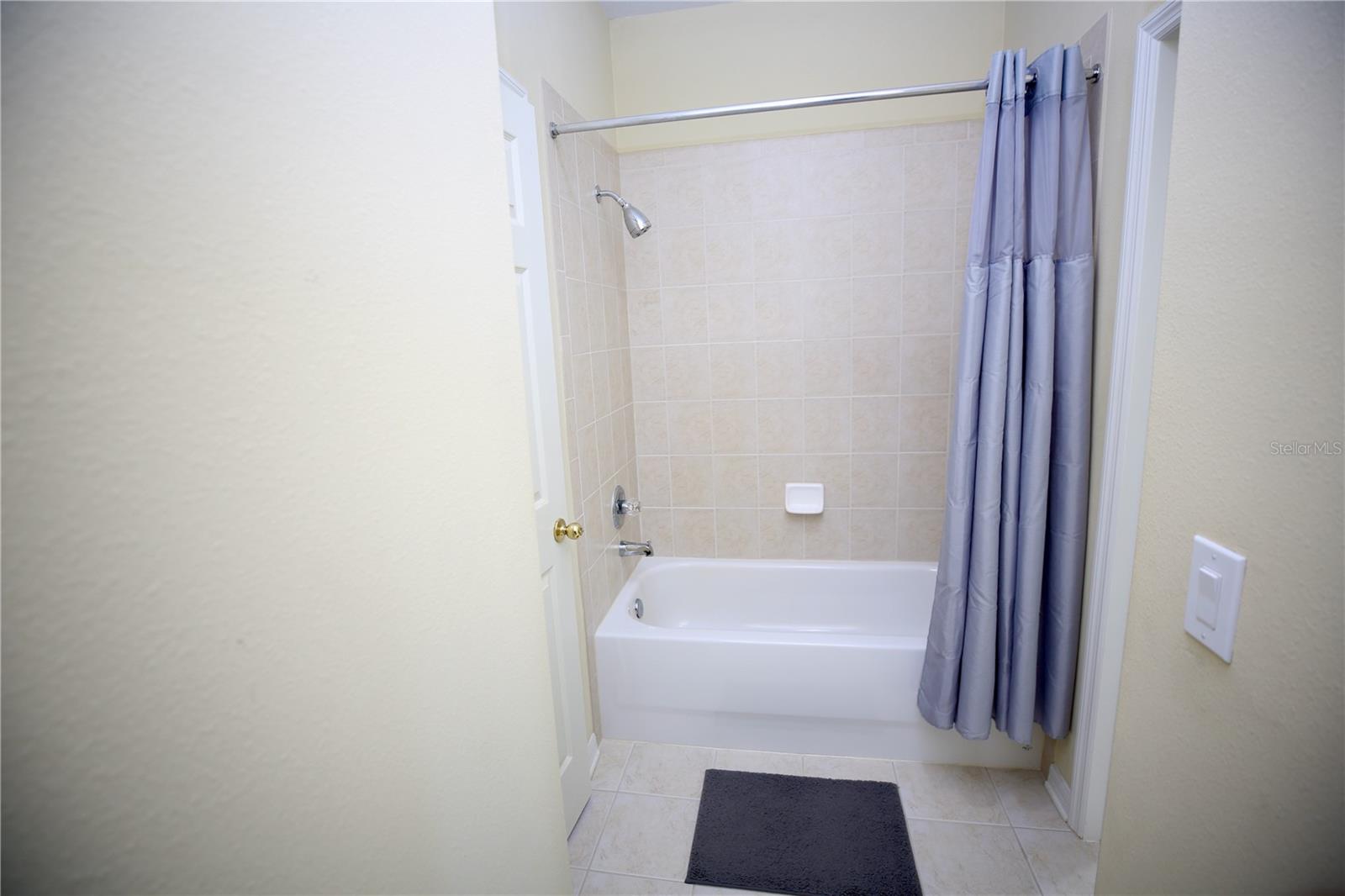 tub area and private toilet that the two rooms share