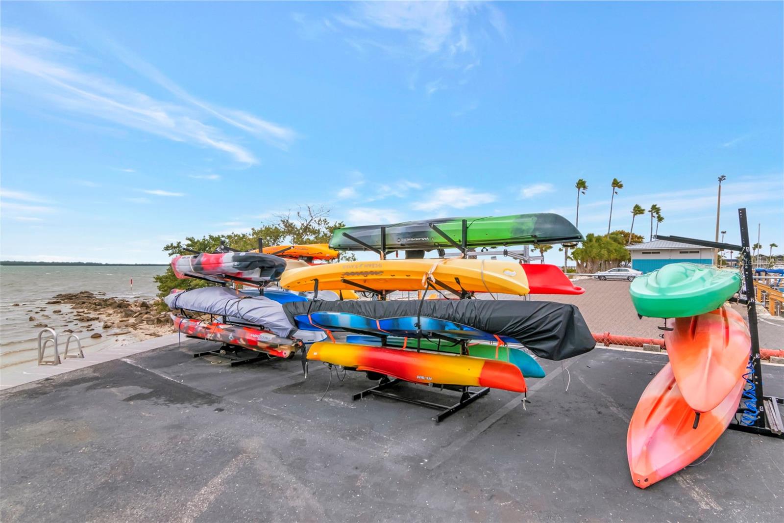 Kayak storage with water access right of the concrete seawall and a small spit of sand to launch off of.