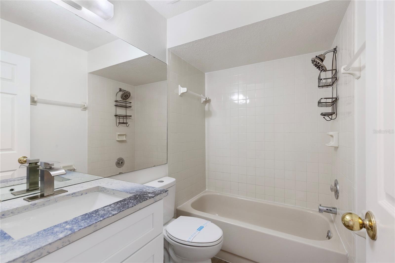 Guest bath with new unique countertops, faucets and fixtures